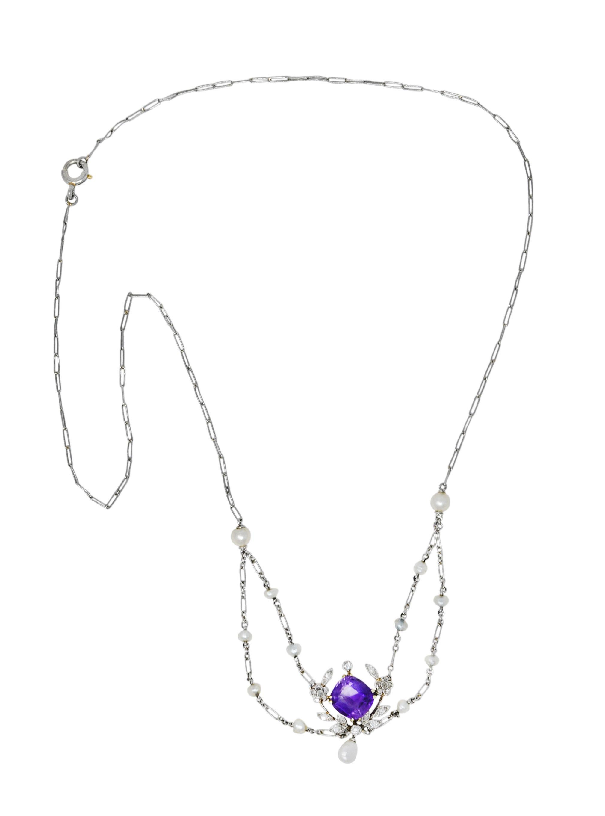 Paperclip style chain features a swagged center

With baroque pearl stations and suspending a baroque pearl drop

Measuring from 2.5 mm to 4.0 mm and very well matched

Centering a cushion cut amethyst measuring approximately 7.5 x 7.1 mm

Medium
