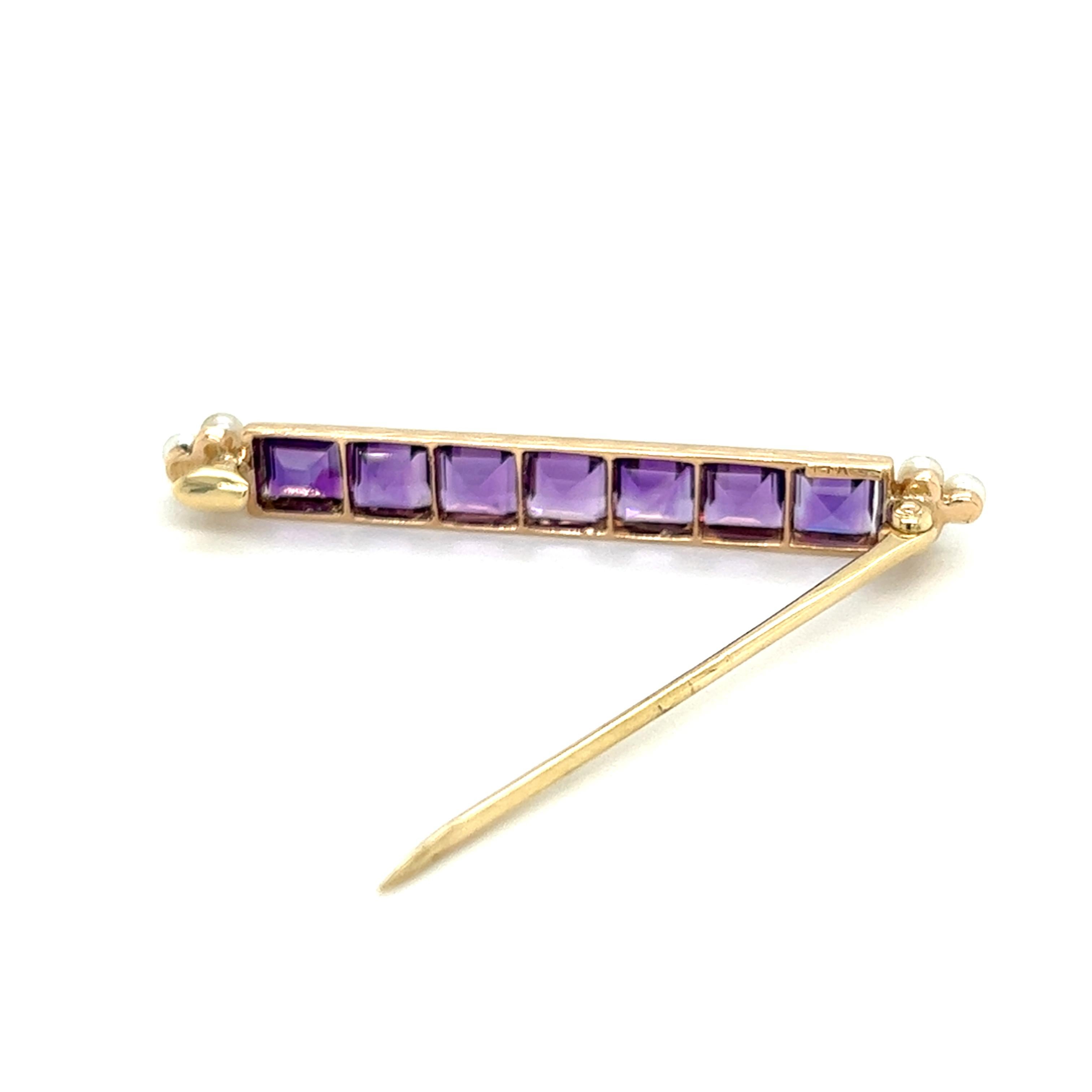 One 14 karat yellow gold Edwardian bar pin set with seven (7) 5mm square cut amethysts and six (6) 2.7mm cultured pearls.  The pin measures two inches long and is complete with a traditional pin closure. The pin is stamped 14K and weighs 2.5 grams