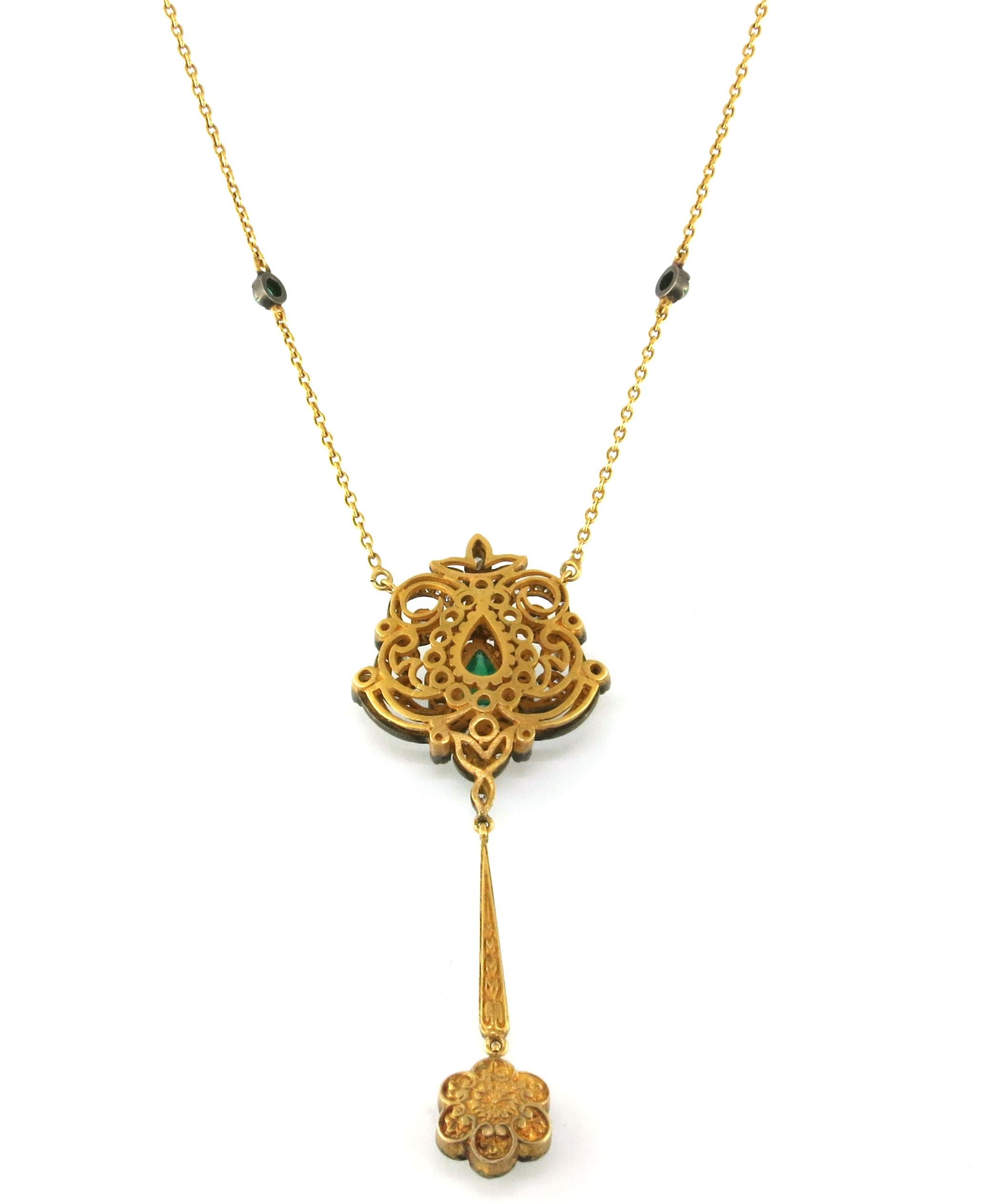 This stunning pendant showcases the beauty of 18 Karat Yellow Gold and a breathtaking 2.01 CT Emerald Cabochon center, surrounded by 2.6 CT Rose Cut Diamonds. With a rustic, antique finish and intricate detailing, this piece is a perfect