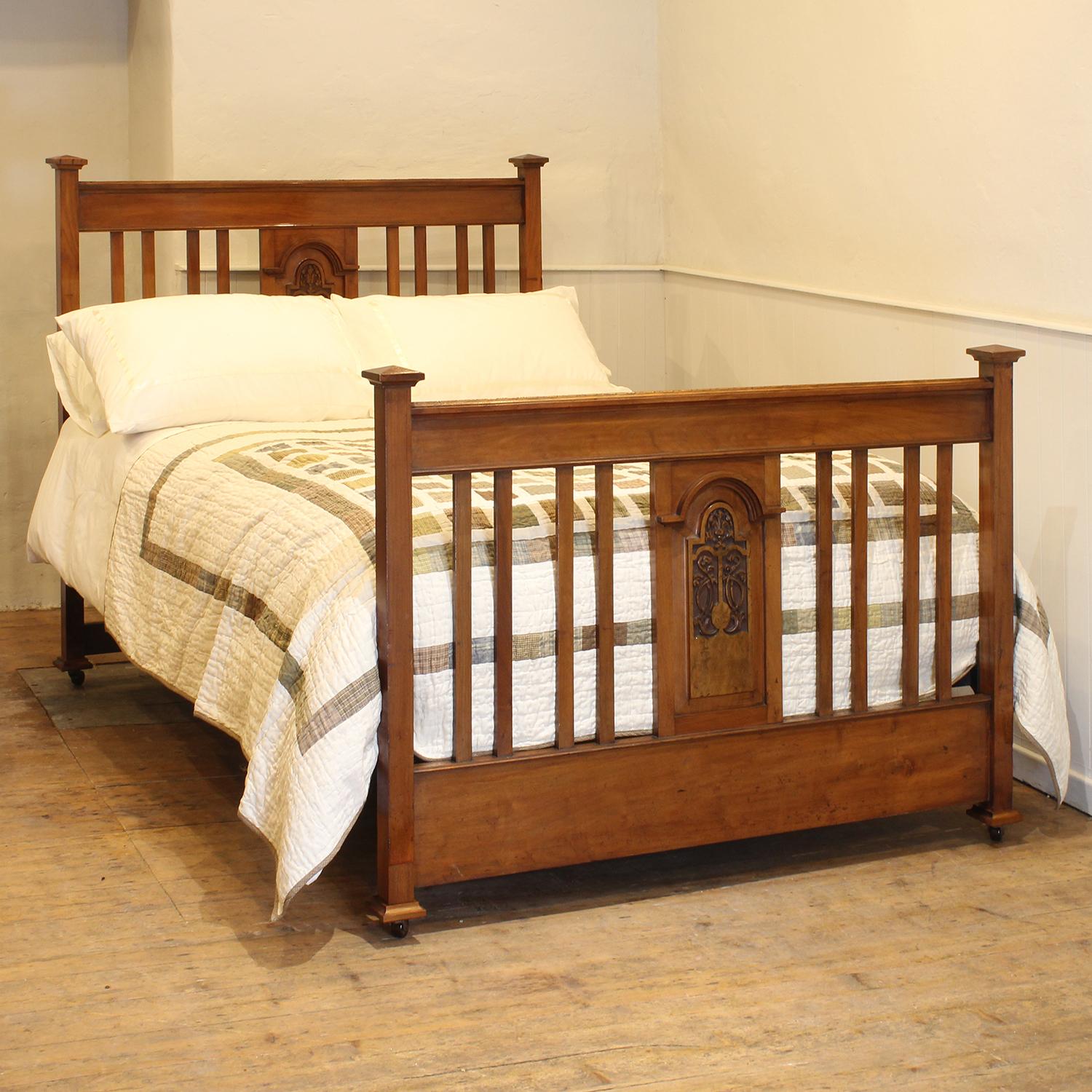 An Edwardian antique bed with pagoda caps and central carved motif.

This bed accepts a standard double, 4ft 6in (54 in), base and mattress set.

The price is for the bed frame and a firm bed base. 

The mattress, sprung bed base, bedding and linen