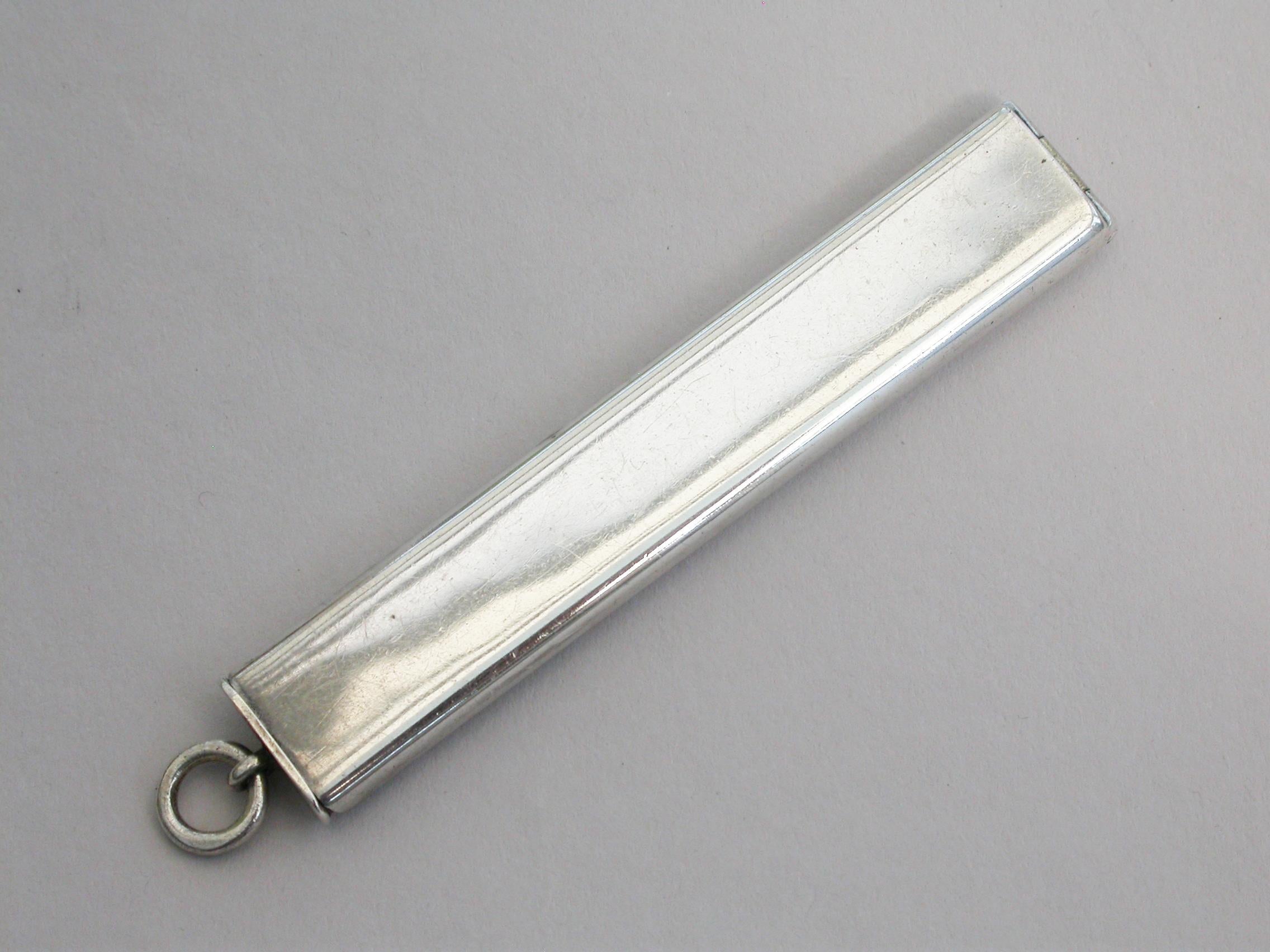 A rare early 20th century miniature silver travelling paint box, of plain narrow rectangular form with attached suspension ring, the hinged lid opening to reveal a silver gilt interior with seven paint compartments and a brush compartment.

By J C