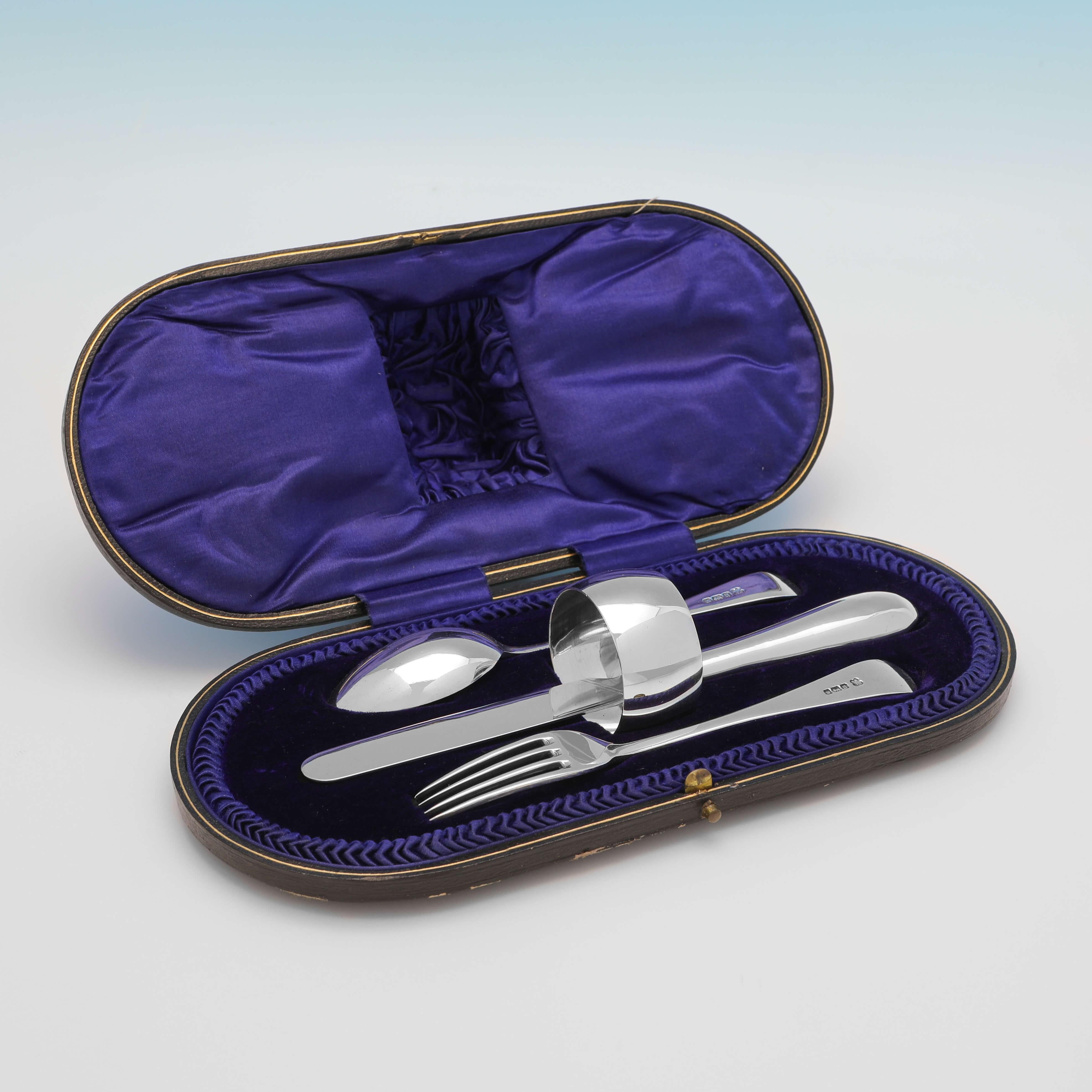 Hallmarked in Sheffield in 1911 and 1912 by Martin, Hall & Co., this handsome, Antique Sterling Silver Child's Set, comprises a knife, fork, spoon and napkin ring, all plain in design, and presented in their original box. 

The box measures