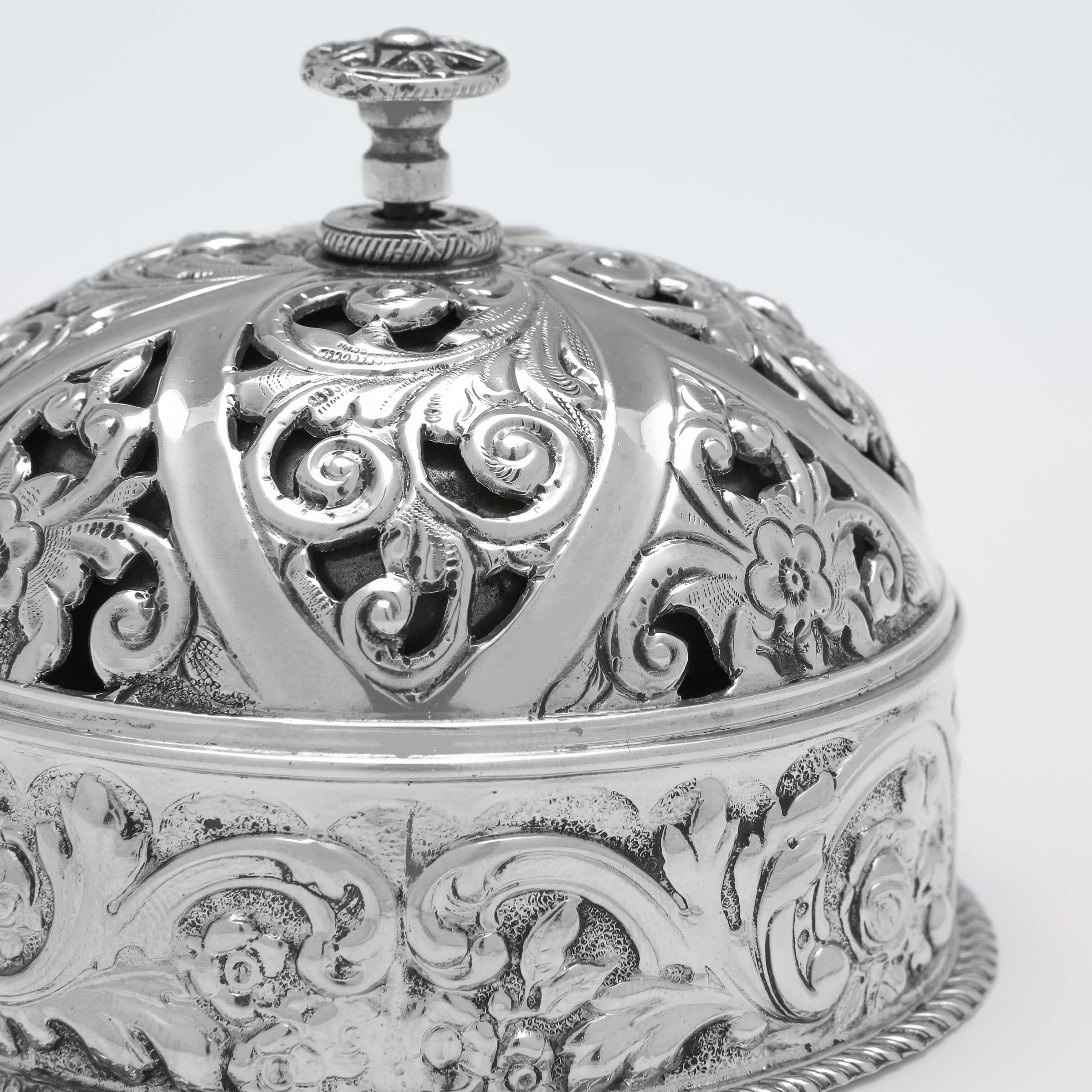 Hallmarked in London in 1903 by William Hutton & Sons, this attractive, Edwardian, antique sterling silver bell, is ornate in design. 

The bell measures 2.75