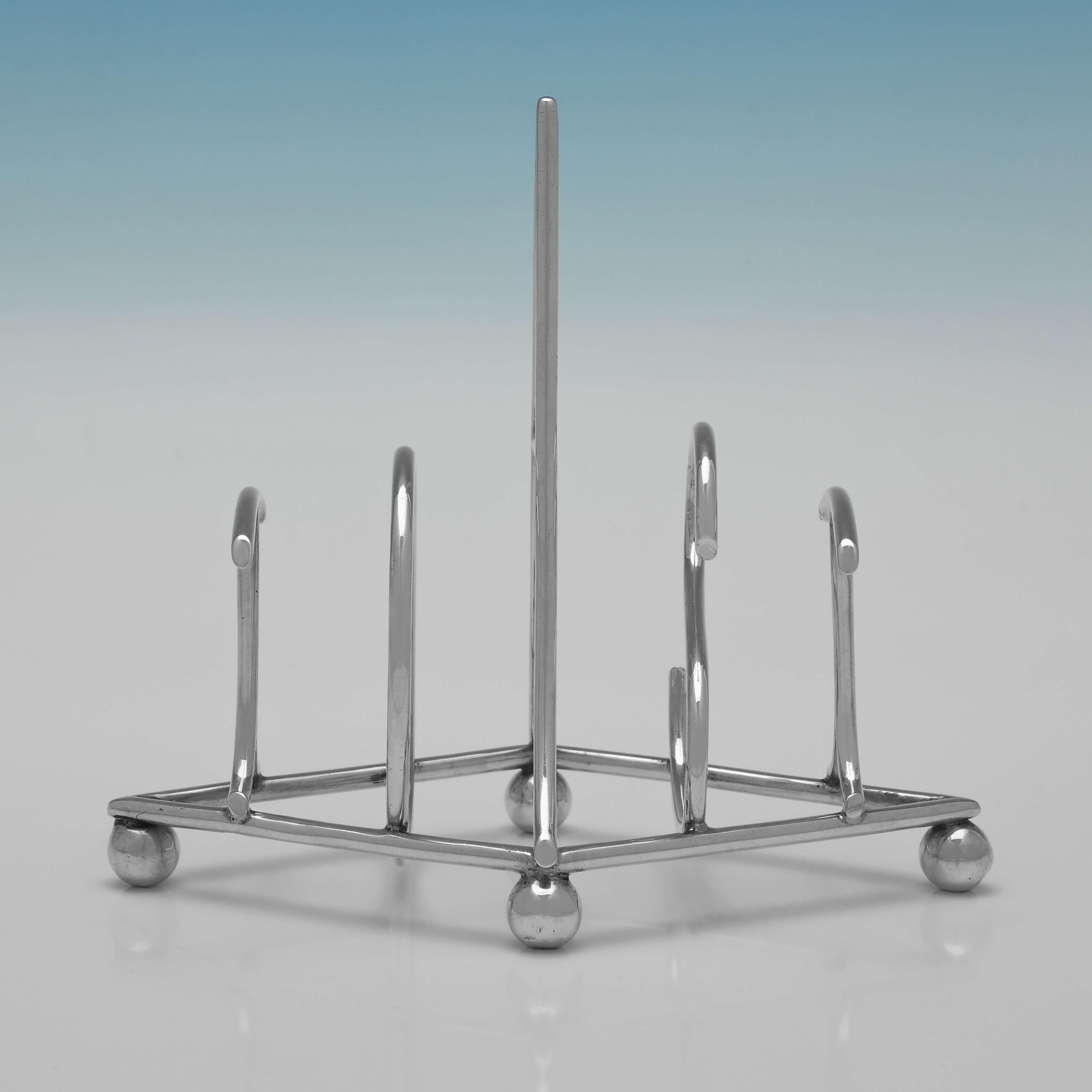 Hallmarked in London in 1904 by Heath & Middleton, this stylish, Edwardian, Antique Sterling Silver Toast Rack, is a novelty design where the bars to hold 4 pieces of toast spell out the word TOAST. 

The toast rack measures 5
