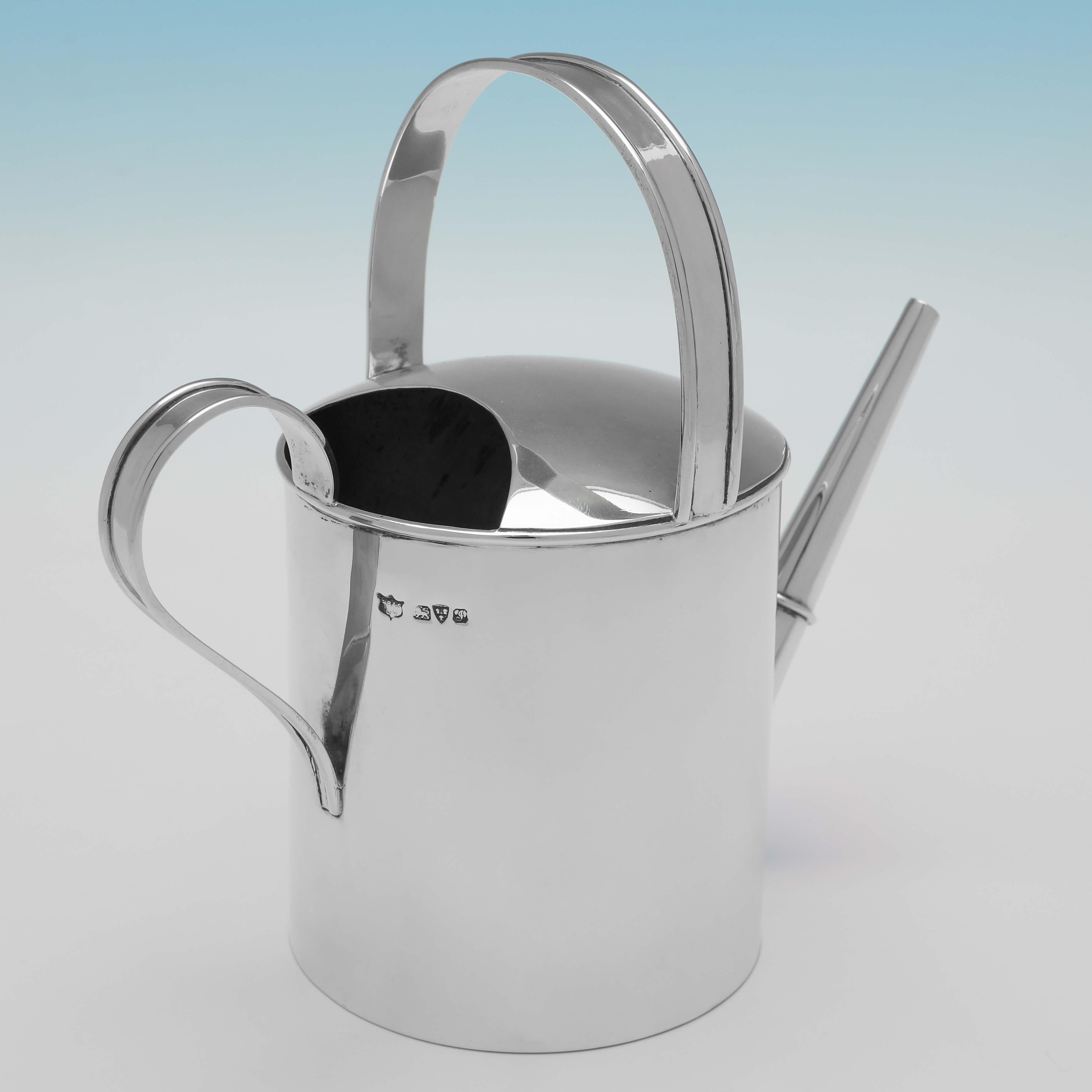 Hallmarked in Chester in 1909 by S. Blanckensee & Son Ltd., this handsome, Edwardian, Antique Sterling Silver Watering Can is plain in design, with reed detailing to the handles. 
The watering can would make a handsome addition to a bar, and would