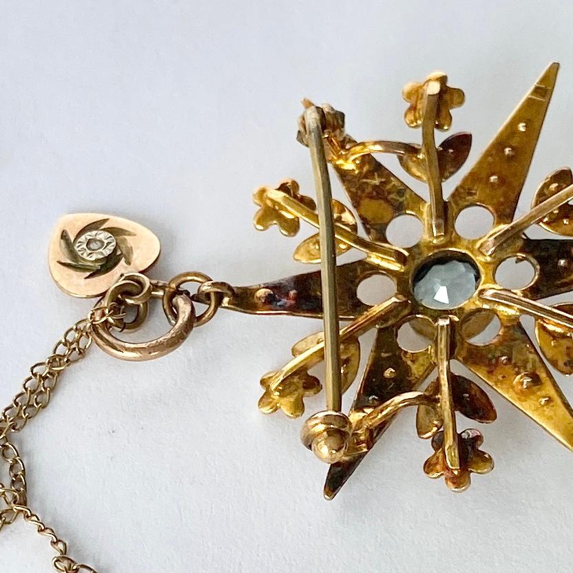 This stunning star is adorned with pearls which are complimented perfectly by the bright yellow 9ct gold. At the centre is an aqua measuring 75pts. On the back there is a pin and there is a loop to ear a a pendant. Also on the chain is a delicate