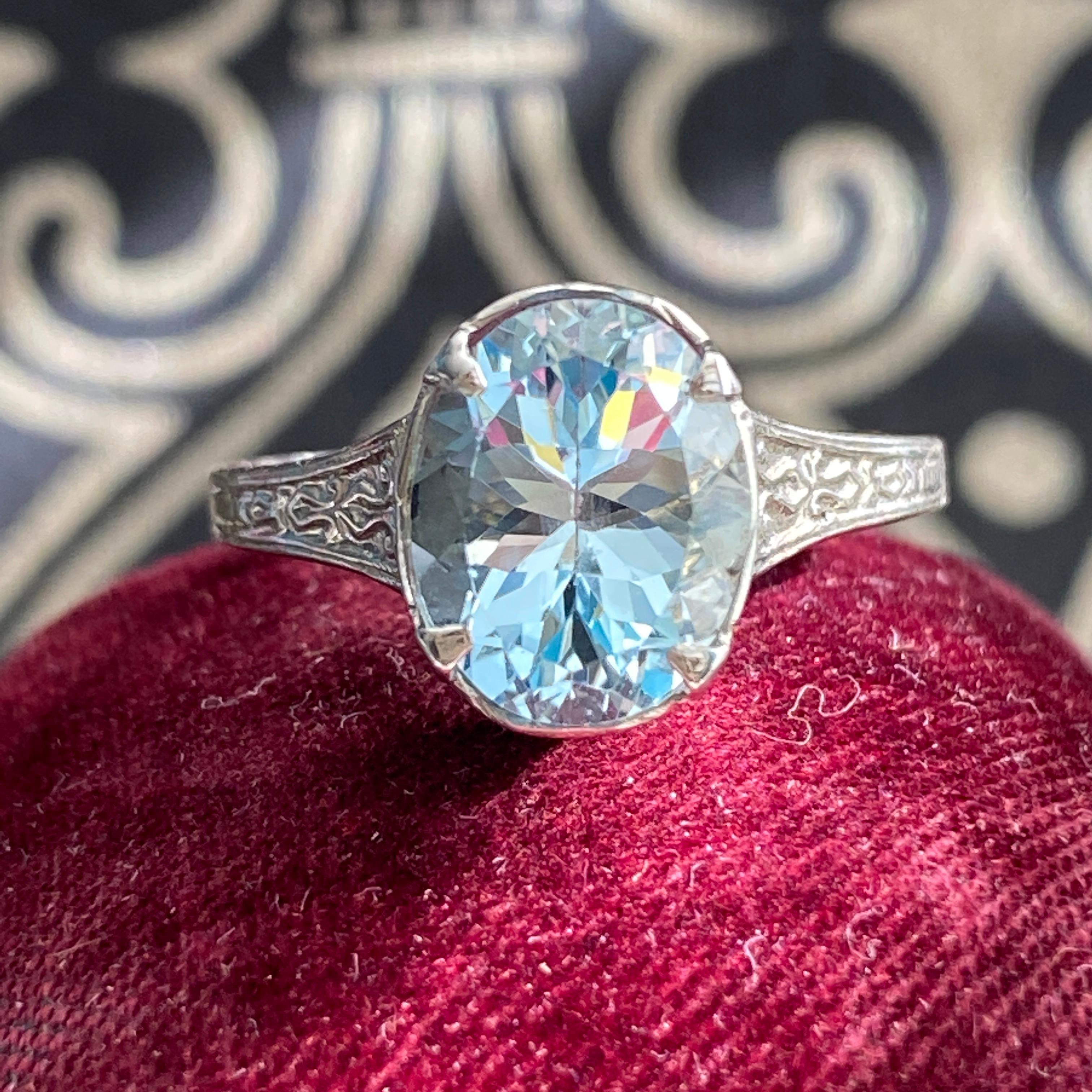 Details: 
Sweet vintage Aquamarine 10K white gold filigree ring. The ring has a sweet filigree pattern surrounding the stone with an engraved band. The aquamarine measures 9mm x 7mm. The ring is stamped 10K on the inside of the band.