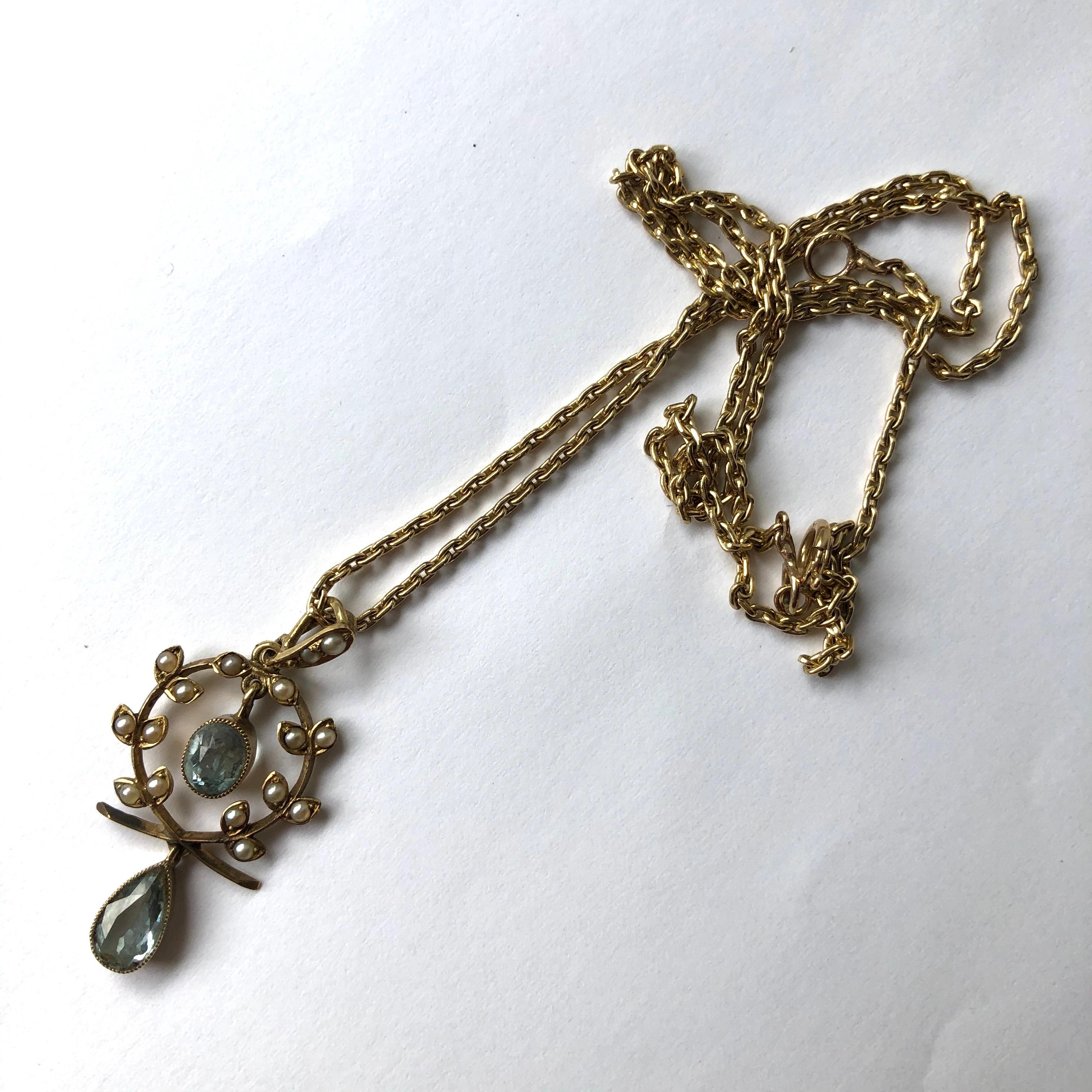 This sweet necklace holds two gorgeous pale blue aqua stones. One is a pear drop shape and one is an oval cut. Around the free hanging oval stone is a delicate halo of seed pearls set on leaves. 

Length: 43cm
Drop From Loop: 35mm
Pendant