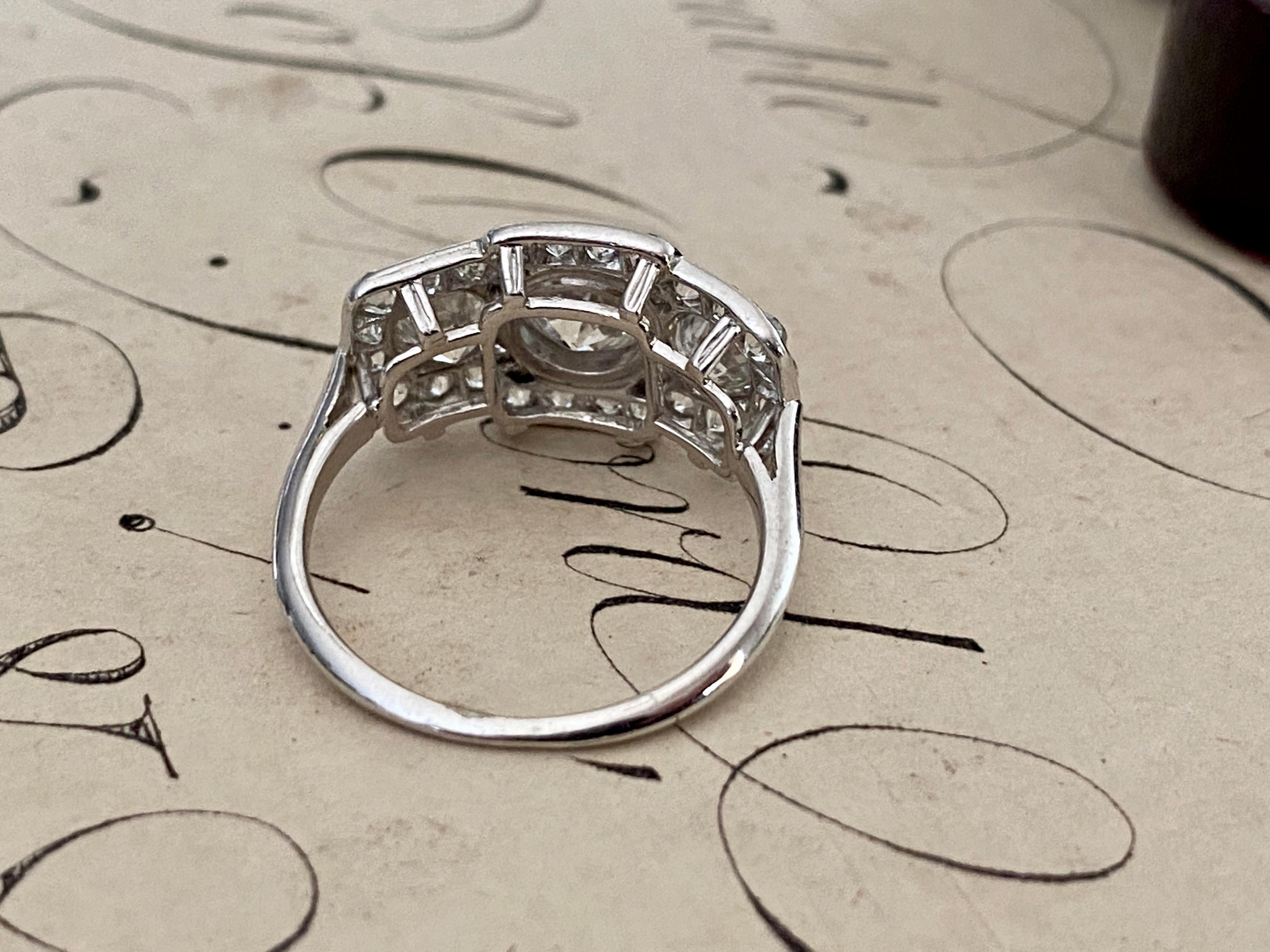 A trio of scintillating old European cut diamonds, together weighing 2.65 carats, flash across the face of this streamlined Edwardian / Art Deco finger hugger. Expertly crafted in platinum, three sparkling diamonds radiate from within a twinkling