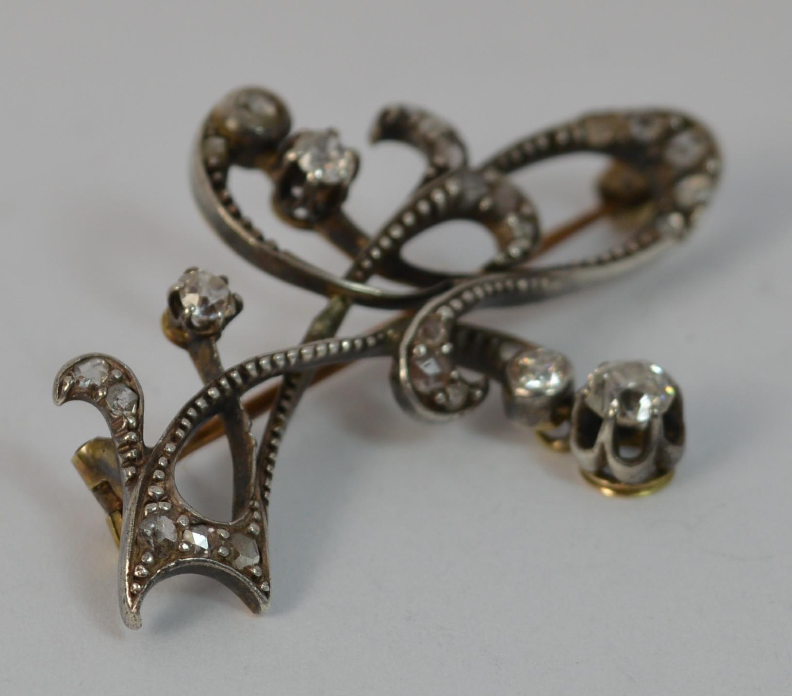 
A very stylish ladies art nouveau period brooch.

Solid 15 carat rose gold example with silver head setting, typical of the period.

Set with old and rose cut diamonds throughout to total approx 0.85 carats. 

Currently a brooch but could be