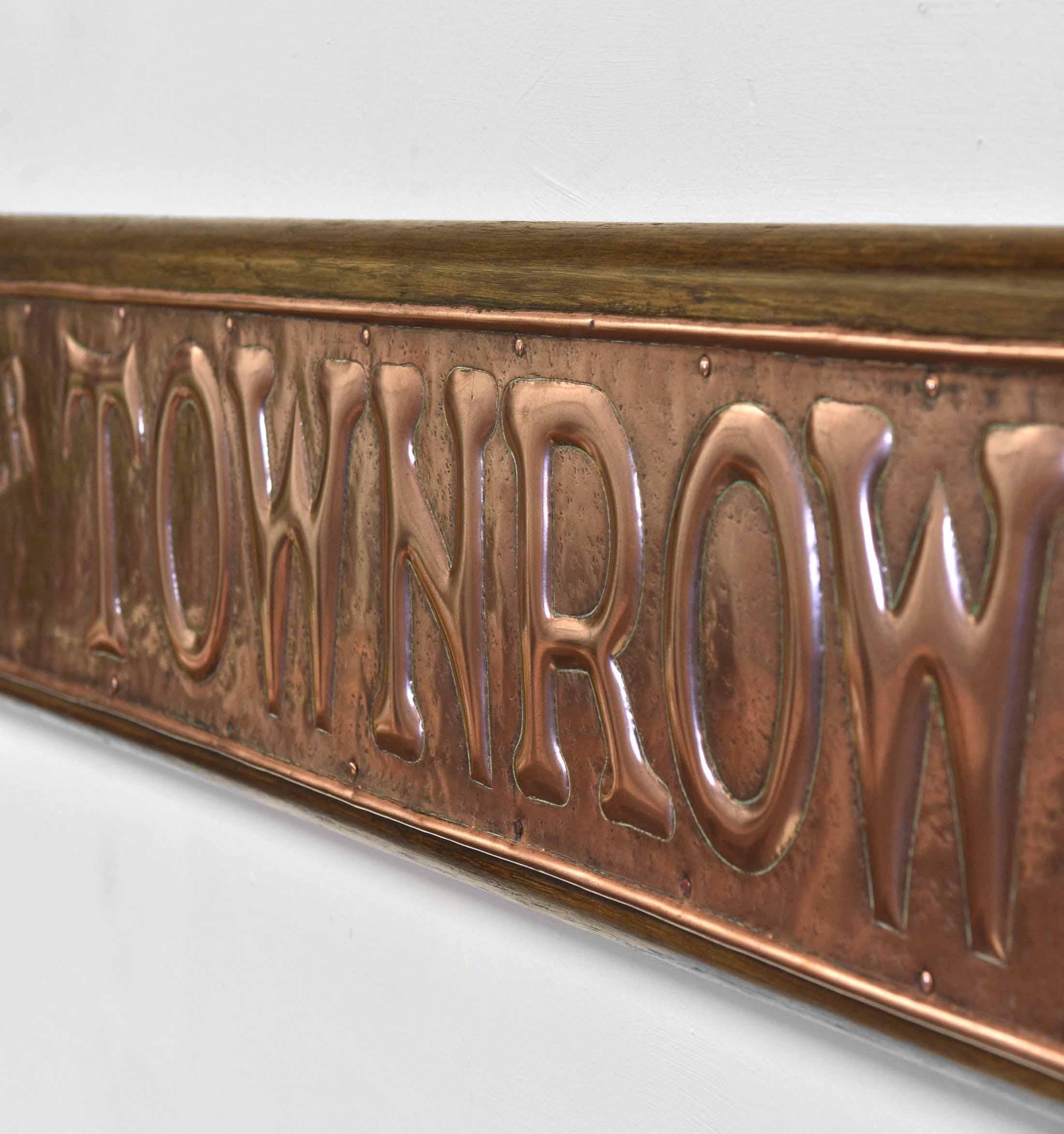 A wonderful English Art Nouveau period polished copper & oak mounted shop sign, 