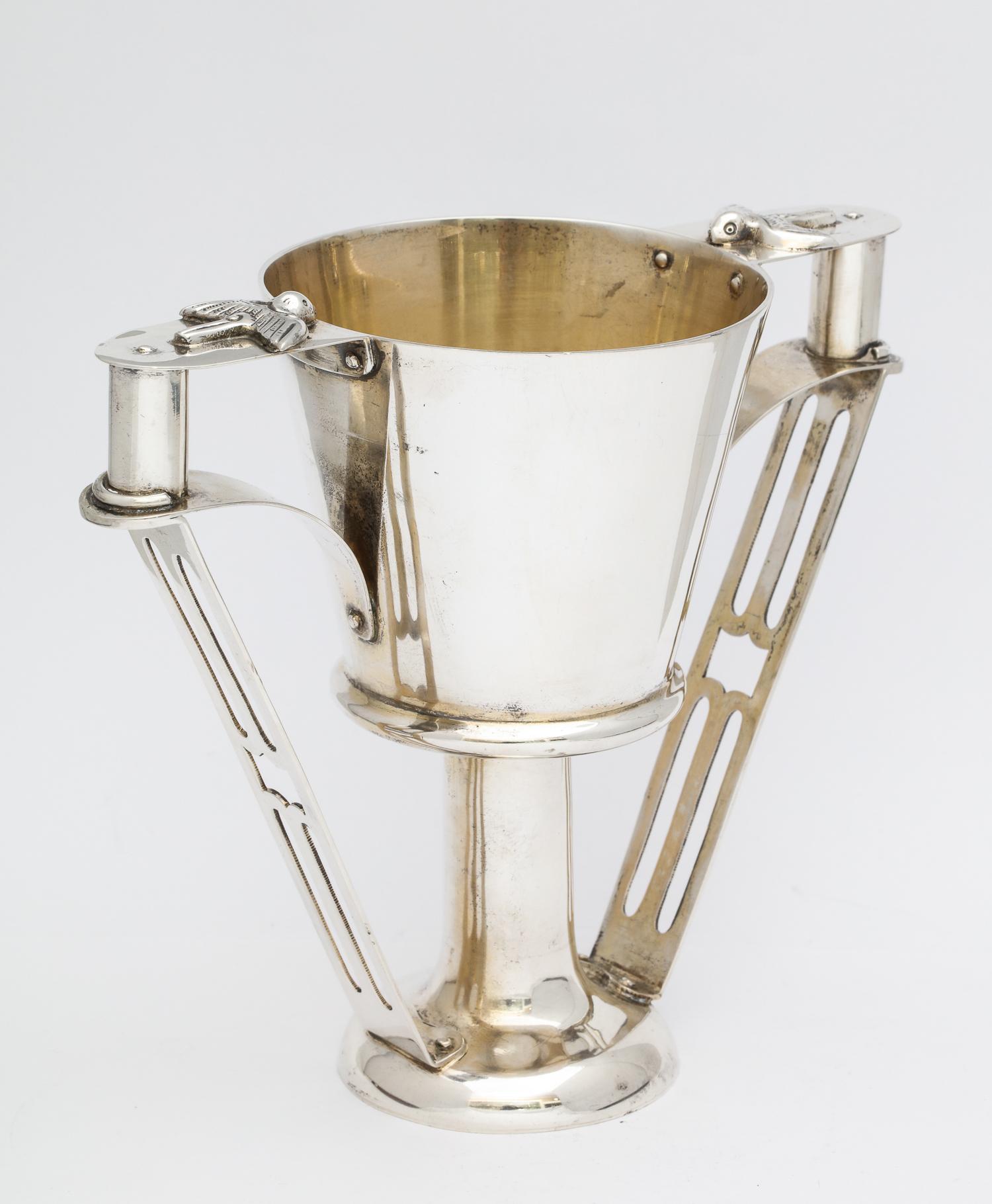 Edwardian, Arts & Crafts, sterling silver two-handled cup, Chester, England, 1906, George Nathan and Ridley Hayes - makers. Pierced handles are topped with birds. Gilded interior. Measures: 5 3/4 inches high x 6 3/4 wide (handle to handle) x 3 1/2