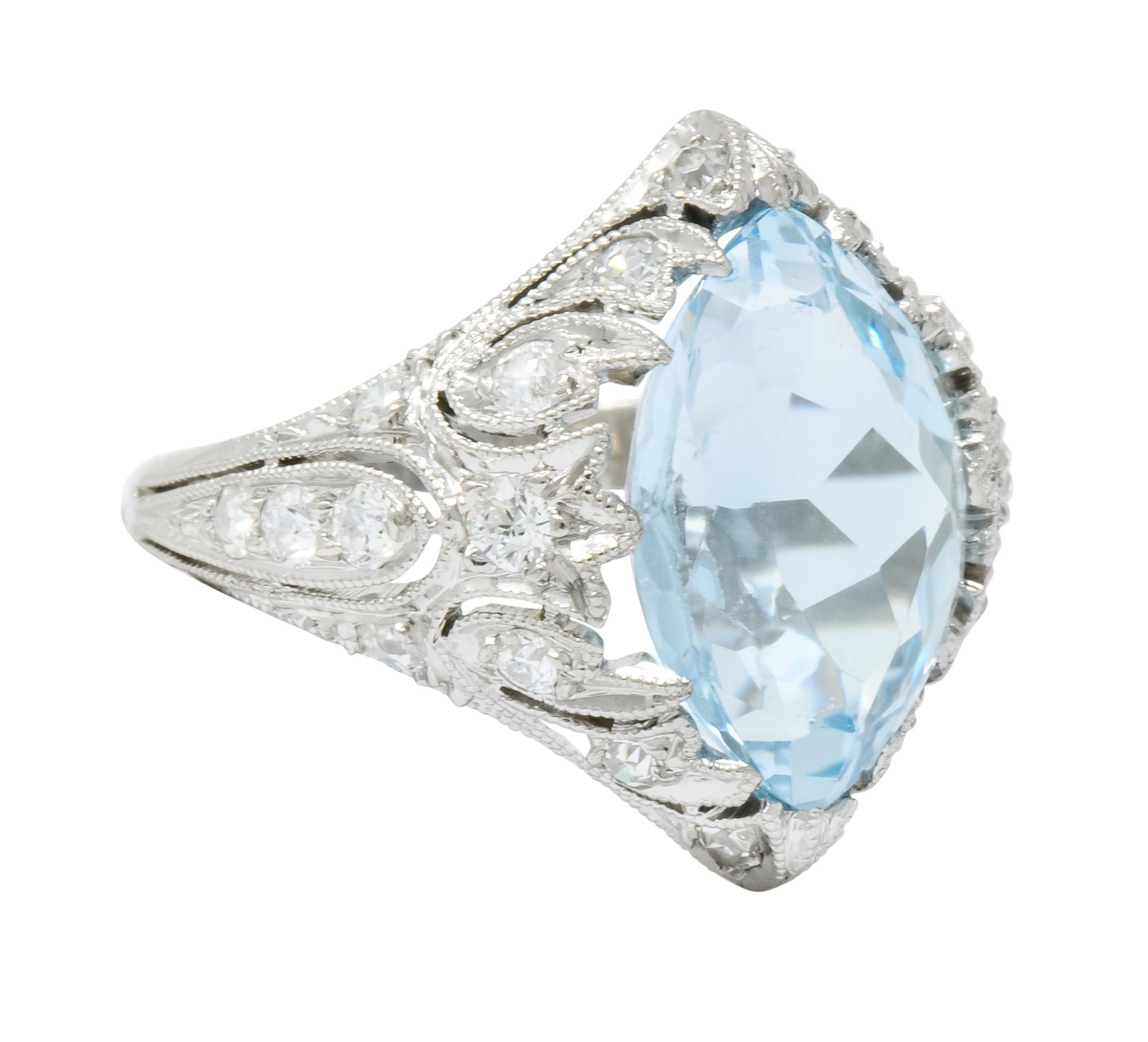 Gemstone ring designed as an ornate navette style mounting decorated with milgrain edges and pierced foliate motif

Centering a marquise cut aquamarine weighing approximately 2.83 carats, transparent with frosty blue coloring

Accented throughout by