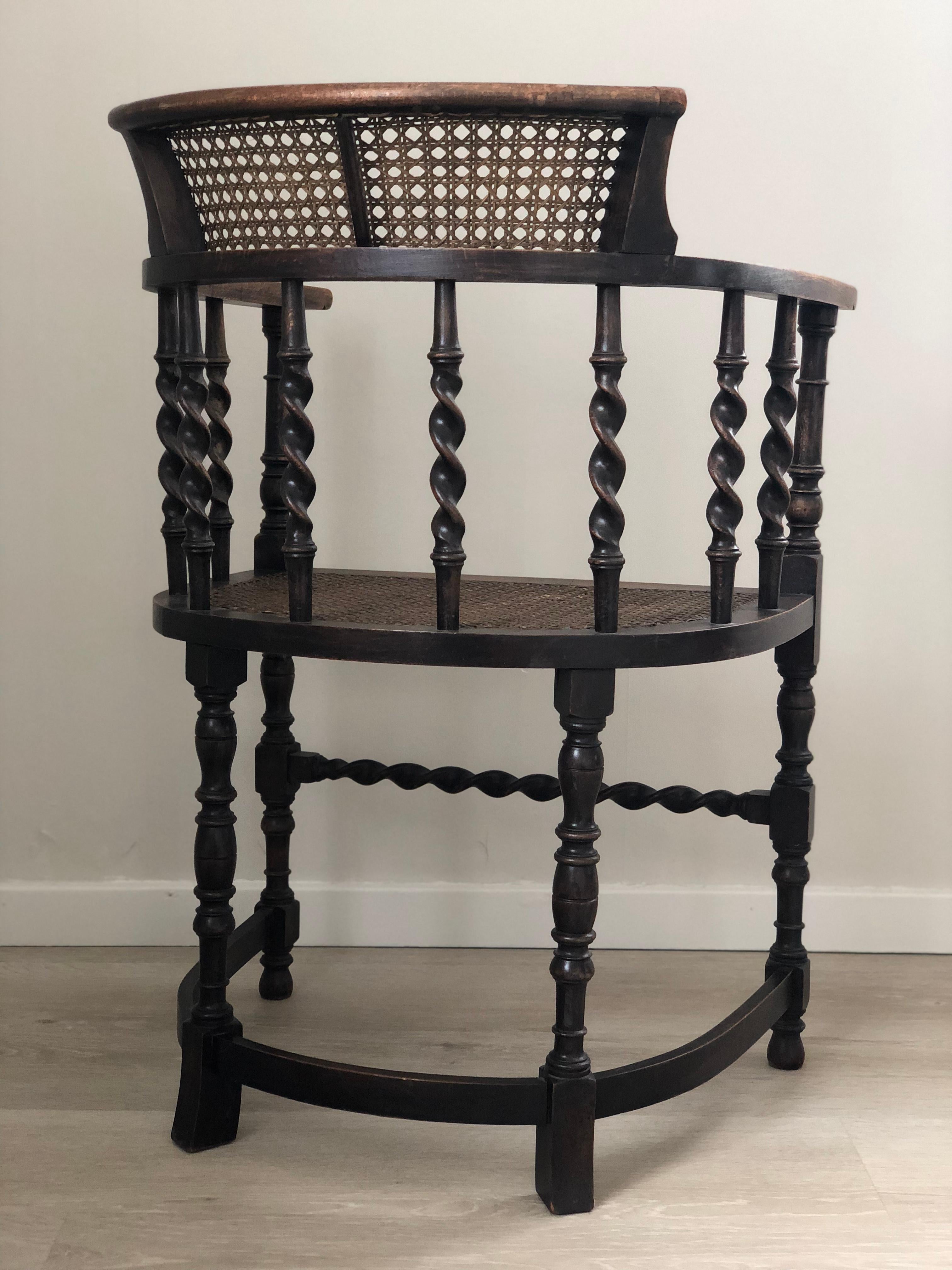 An English armchair beautifully carved with barley twist supports and bobbin turned legs from the early 20th century. Finished with a cane seat and backrest.
The beech wood chair and cane are in good condition. The cane seat is from a later period.