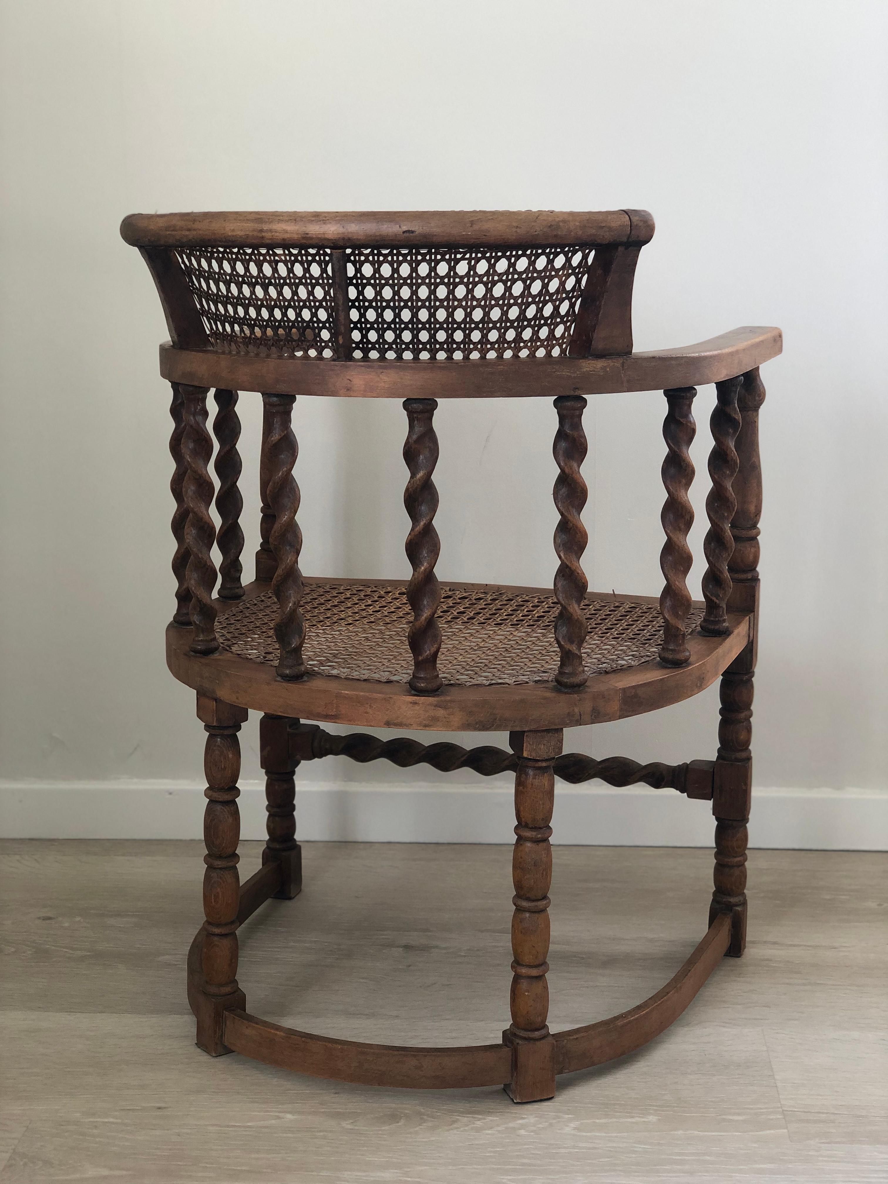 An English armchair beautifully carved with barley twist supports and bobbin turned legs from the early 20th century. Finished with a cane seat and backrest.
The beech wood chair and cane are in good condition. The cane seat is from a later period.