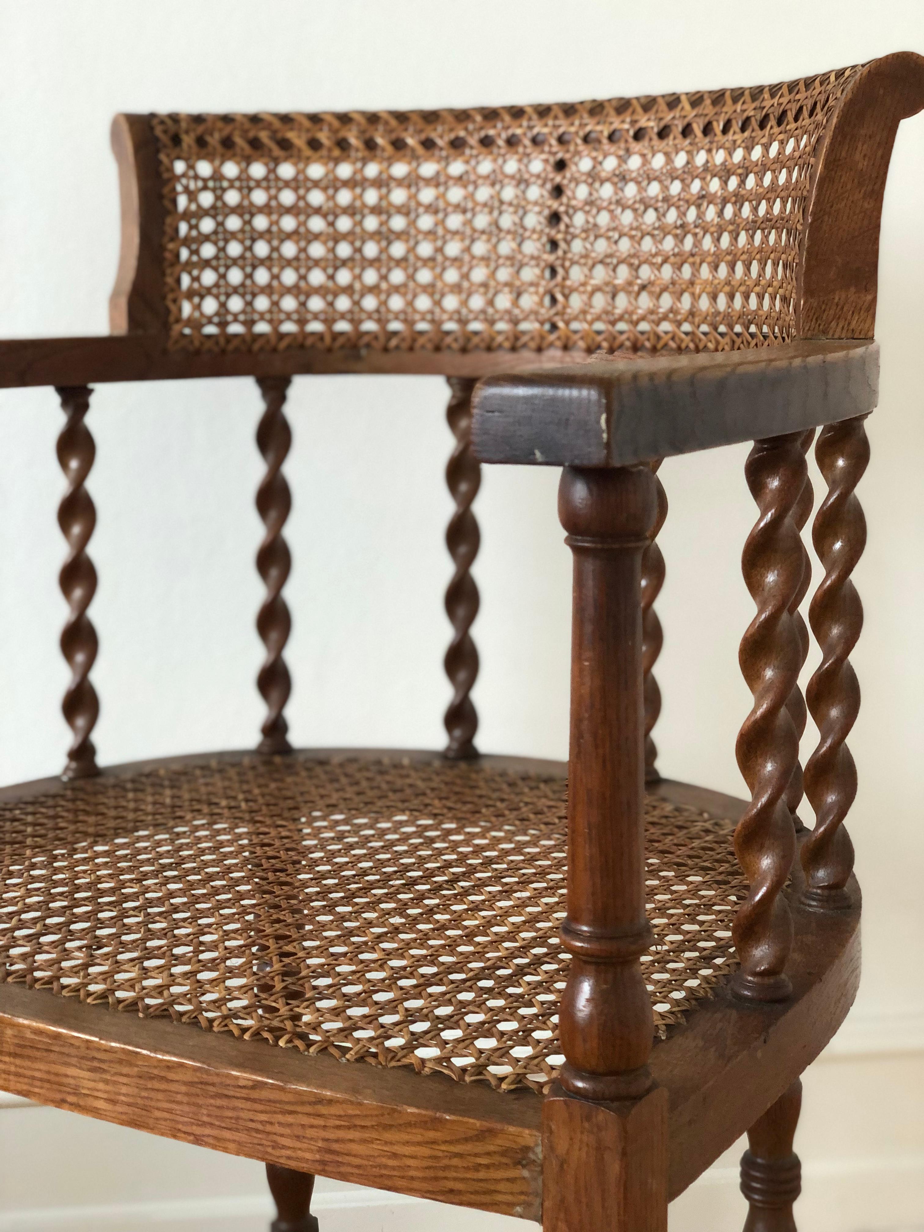 This Edwardian chair, crafted from solid beech in the early 19th century, is both sturdy and timeless. Featuring a seat and backrest made of cane, it provides reliable comfort and support. The design is complemented by barley twist legs and matching
