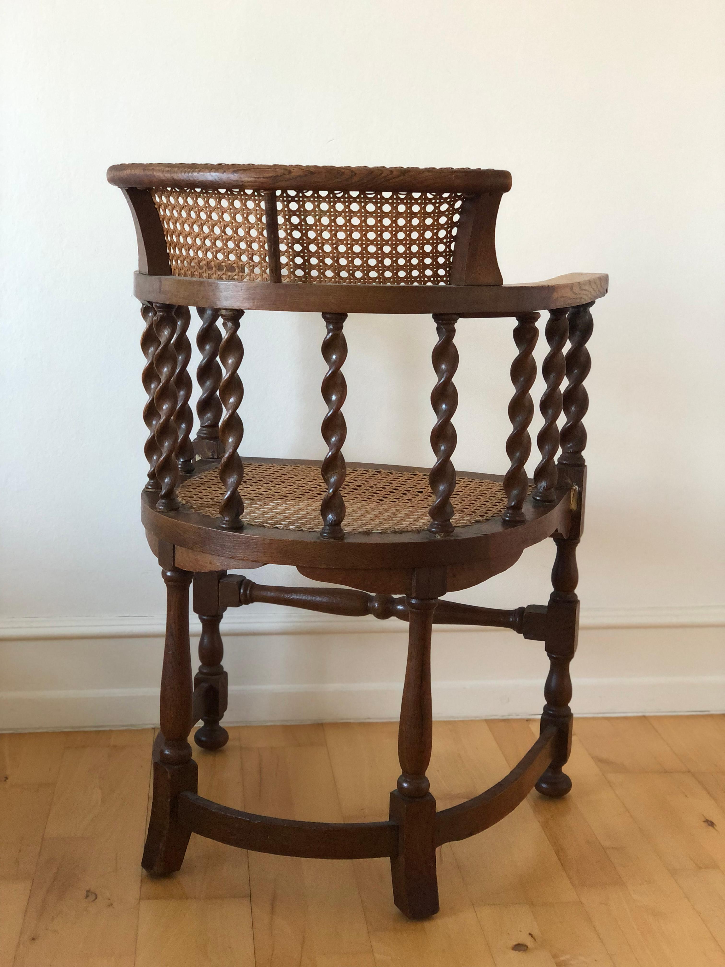 This Edwardian chair, crafted from solid beech in the early 20th century, is both sturdy and timeless. Featuring a seat and backrest made of cane, it provides reliable comfort and support. The design is complemented by barley twist legs and matching