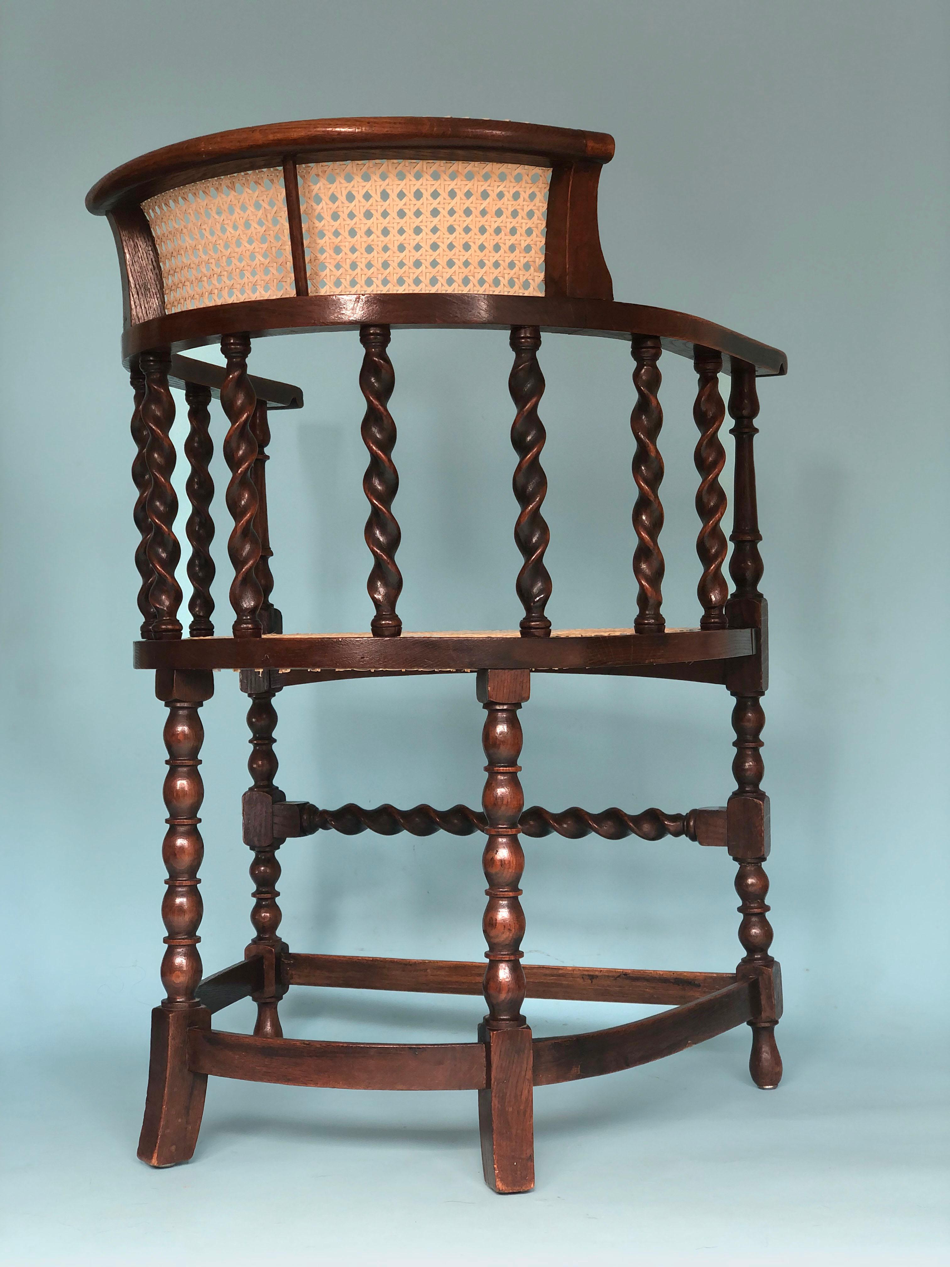 An English corner chair with barley twist supports and bobbin turned legs from around 1900. The beech wood chair is in very good condition. The cane seat is from a later period. 

Object: Armchair
Designer: Unknown
Style: Antique
Period:
