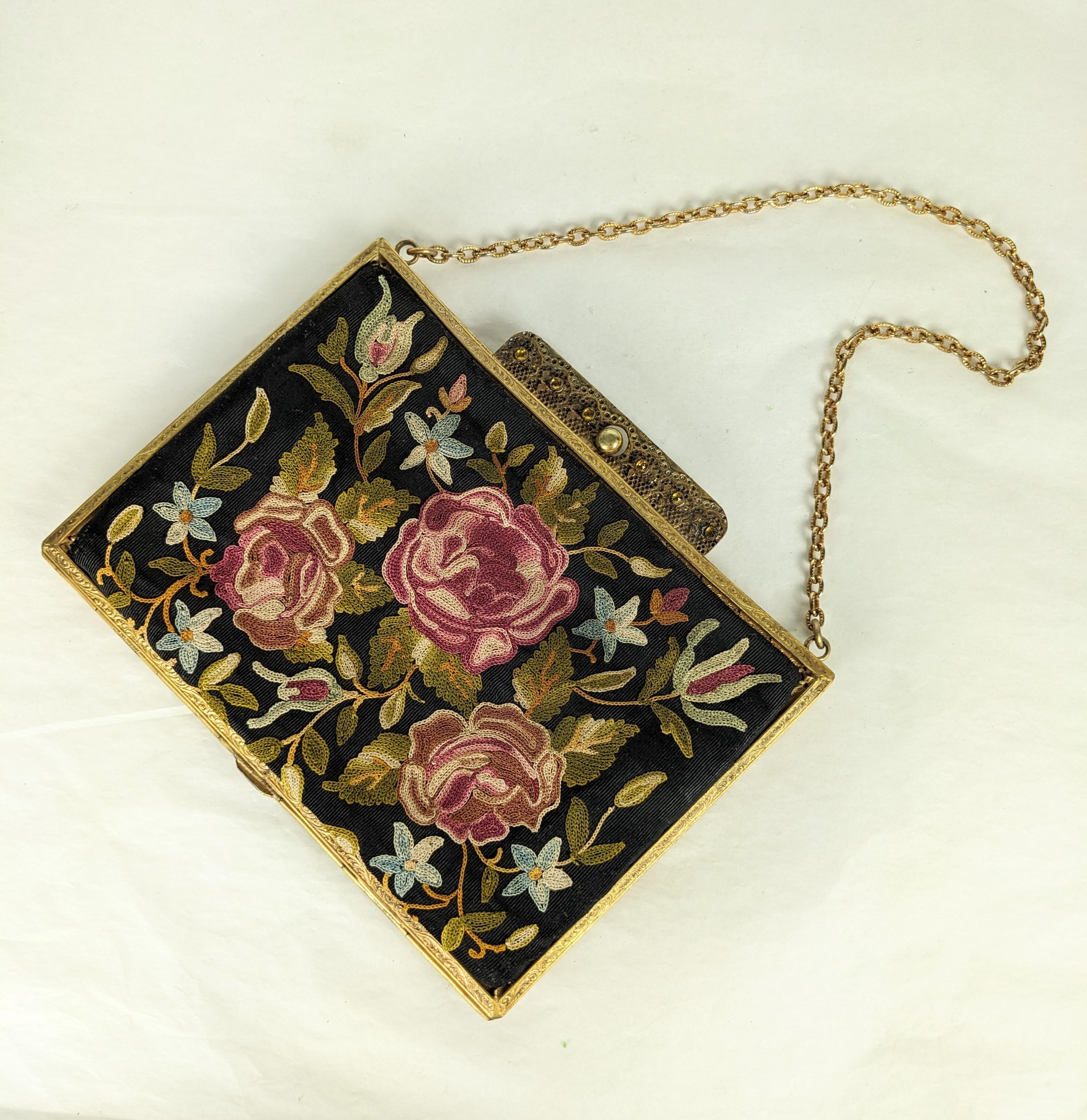 Lovely Edwardian Beauvais Embroidered Bag from the turn of the 20th century in France.  Lavishly hand embroidered with roses on black silk faille within a bronze frame set with a citrine crystal clasp. Silk lining with compartments. 1910 France.