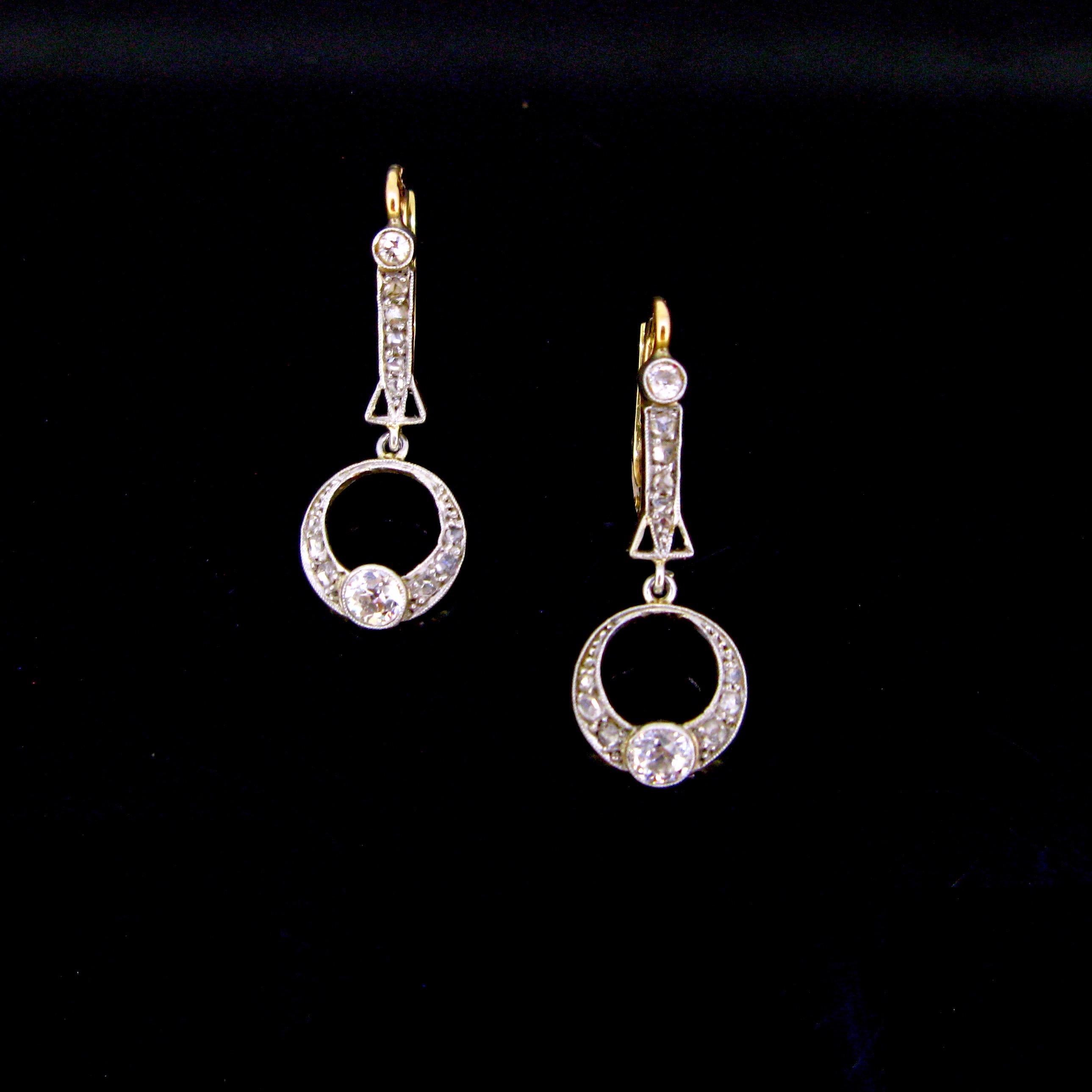 ritagem presents:

This beautiful pair of earrings is from early 20th century. The dangling bottom is adorned with an old cut diamond of 0.20ct approximately and rose cut diamonds, set on platinum. The top is also set with rose cut diamonds and an