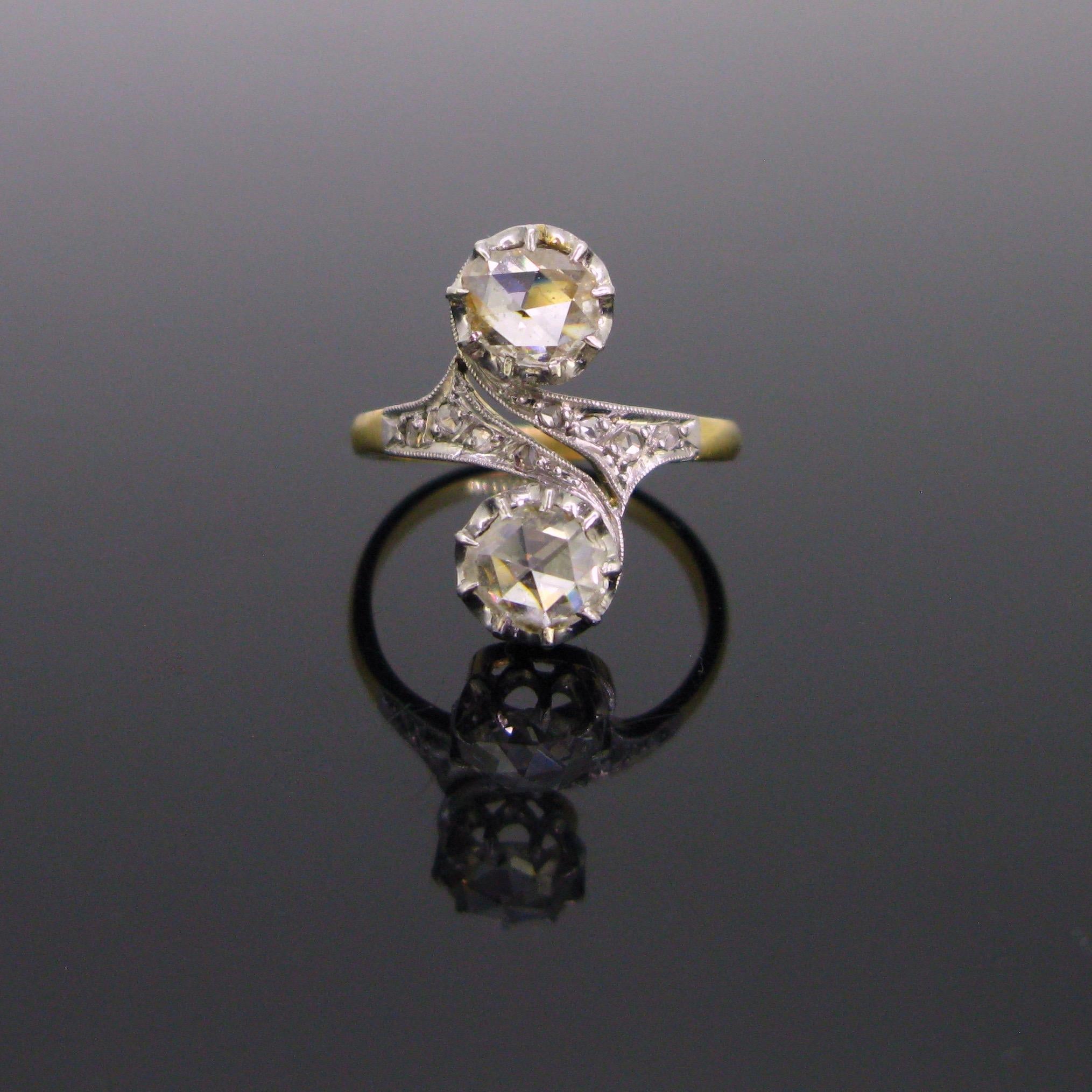 This ring was perfectly handcrafted in 18kt gold and platinum. It features 2 vibrant and lively rose cut diamonds. One of it presents a small chip on the edge however they are well secured by the platinum prongs. The centre was nicely opened and