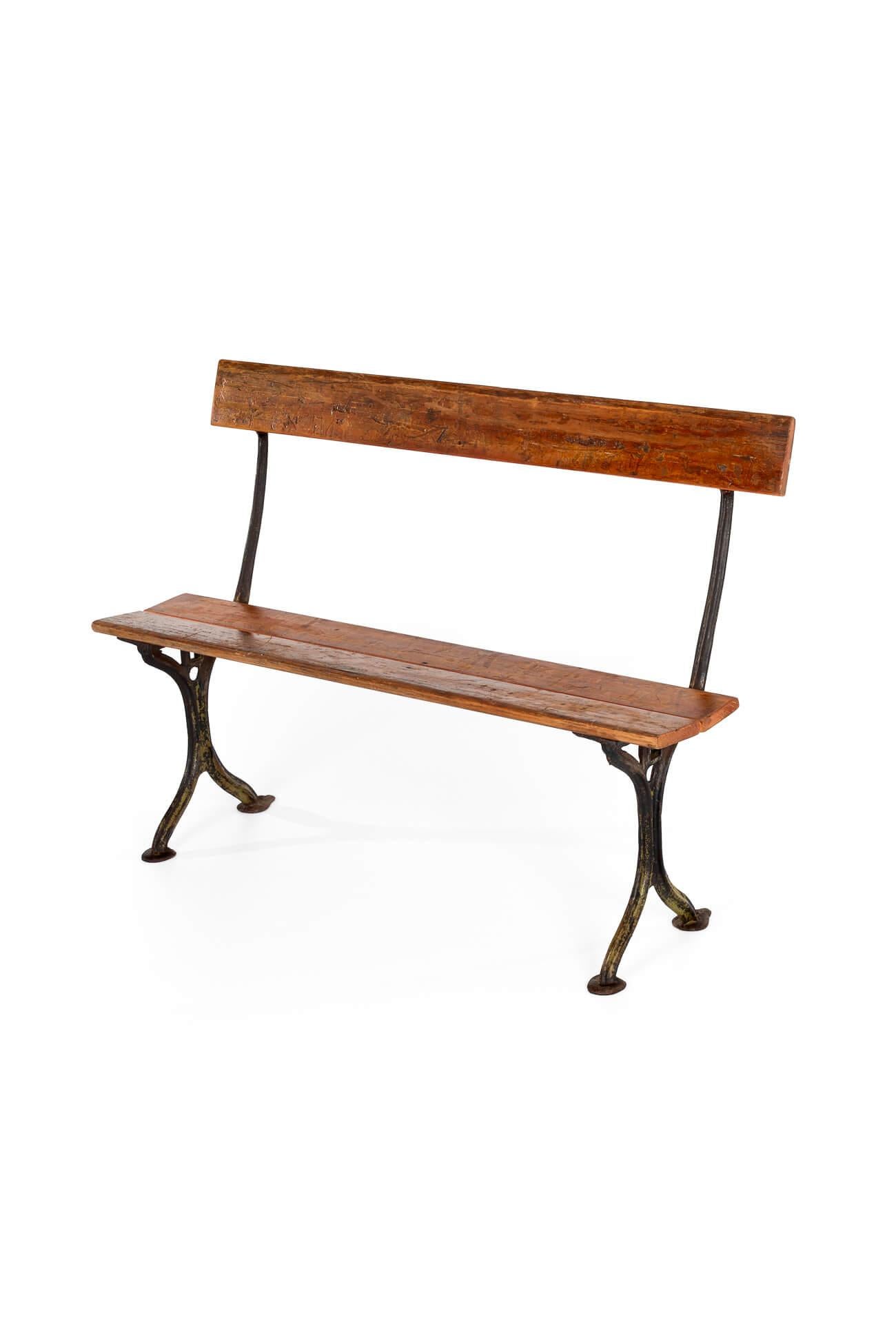 A simple, diminutive Edwardian ironwork bench.

The seat and backrest, both in beech, are supported by a pair of ironwork supports and finished on beaten pad feet.

Strong and sturdy with no rocks or wobbles.

Traces of the original green paint on