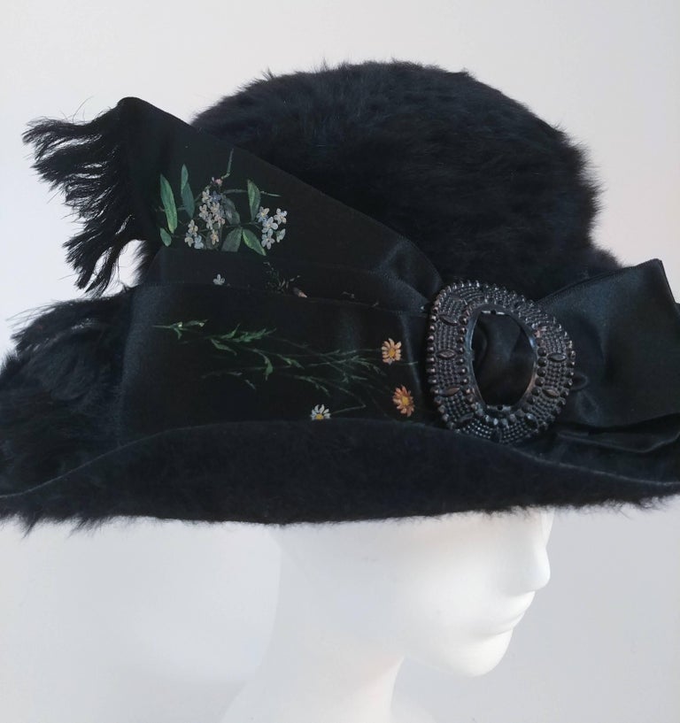 1910s Black Fur Felt Picture Hat w/ Painted Ribbon. Fur felt hat, silk ribbon embellishment with decorative buckle. Velvet ribbon trim on brim of hat. Lined interior. Fits large due to large hair of the 1910s. 