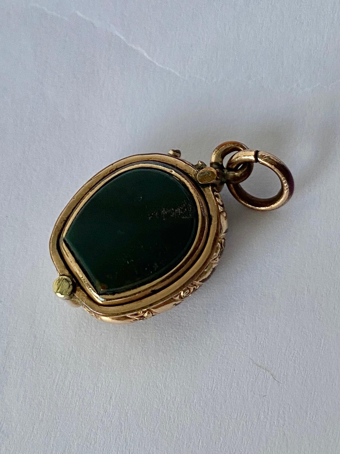 This classic 9ct gold fob holds a carnelian and bloodstone but the unusual element is that it is actually a locket! As you can see the locket has a slide opening and reveals a secret compartment to put a loved ones photo or lock of hair. 

Stone