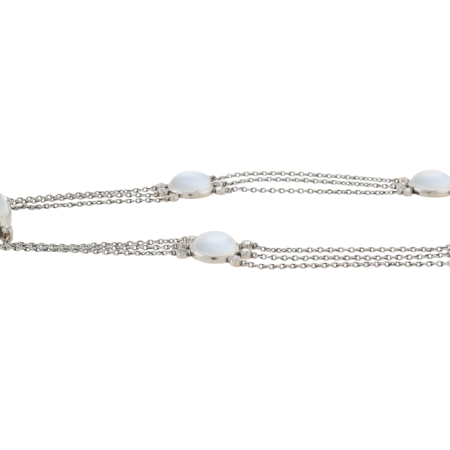 An absolutely stunning diamond and moonstone necklace from the Edwardian (ca1910s) era! Crafted in platinum, this unusual piece features eight luminescent blue moonstones of varying shape, each resting in a platinum bezel setting. Apart from the