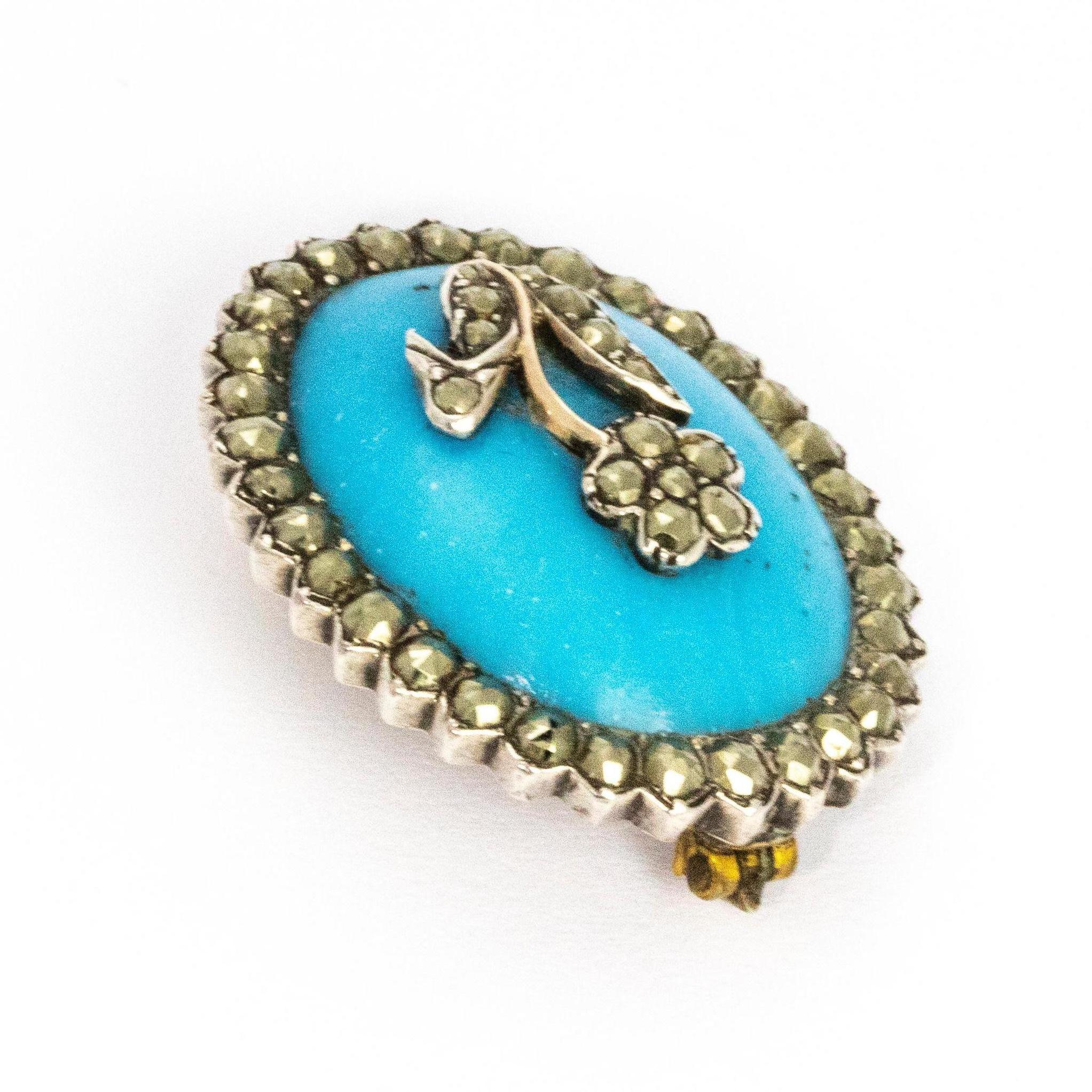 Forget me not flower mounted on a beautifully bright blue resin brooch surrounded by a halo of marcasite. 