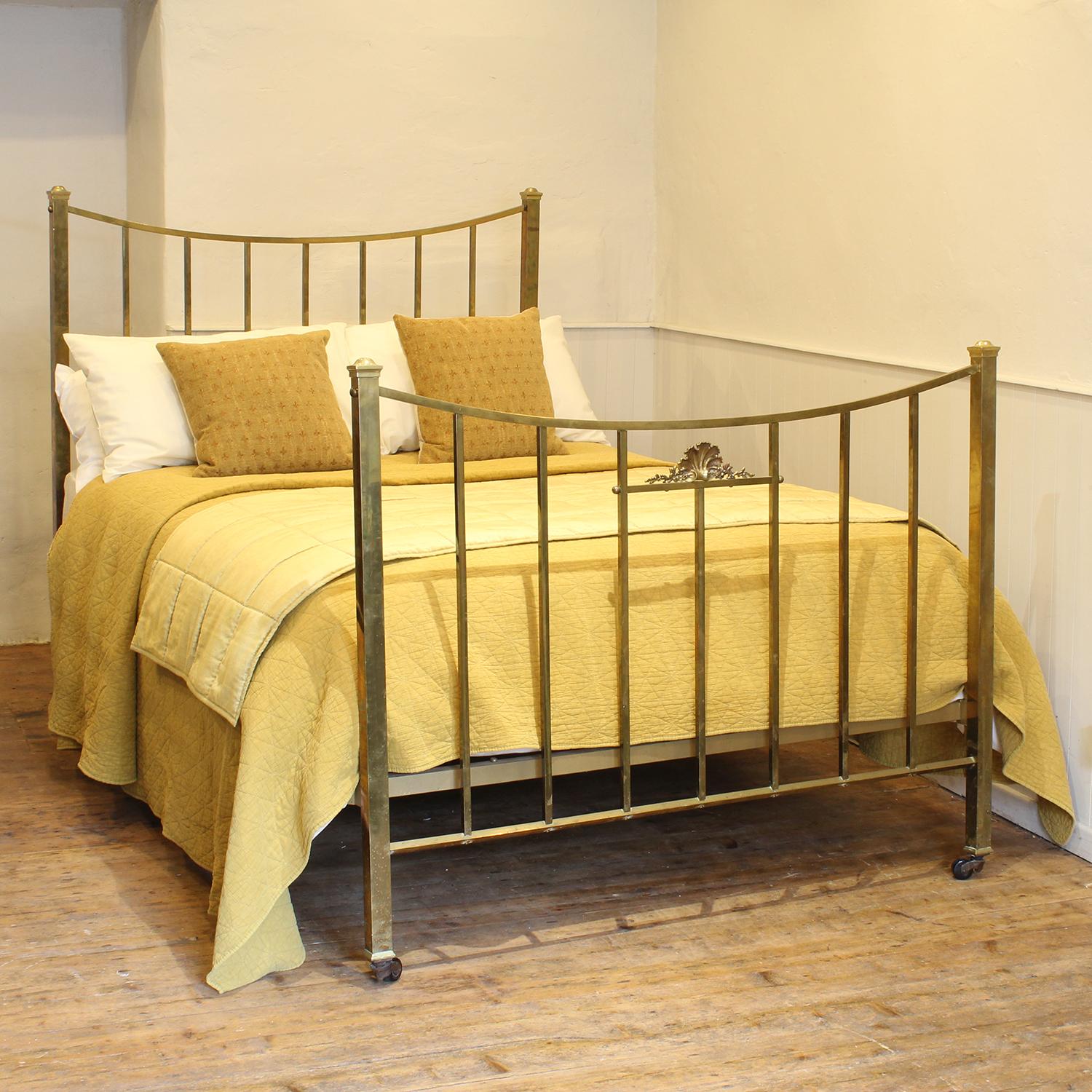 An attractive Edwardian bedstead with square section brass rails, sweeping curved top rail and central decorative cast feature in the centre of the foot panel.

This bed accepts a double size 4ft 6in wide (54 inch or 135cm) base and mattress.