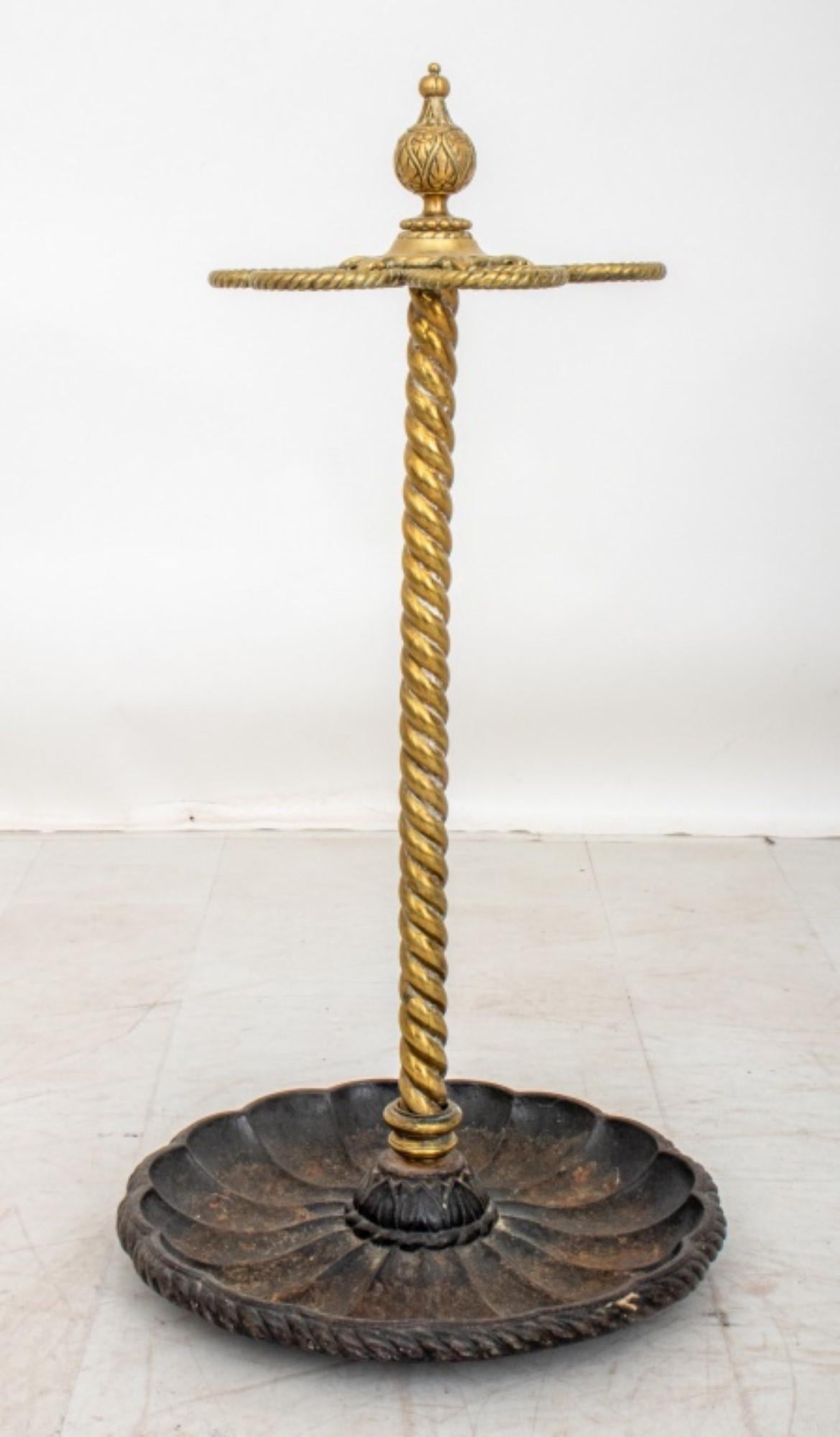 The Edwardian Brass & Cast Iron Stick & Umbrella Stand, dating from circa 1900,
Has approximate dimensions of 30 inches in height and 15 inches in diameter.
 This piece serves the purpose of a cane, stick, or umbrella stand, showcasing