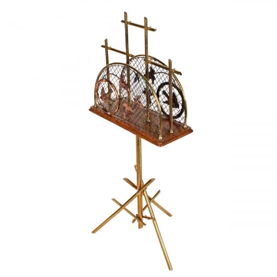 A late 19th to early 20th century brass and oak magazine or music stand.

The stand is made in an arts & crafts design, with a central column supported by a tripod made up from six brass rods.

The same design is repeated in the music rack