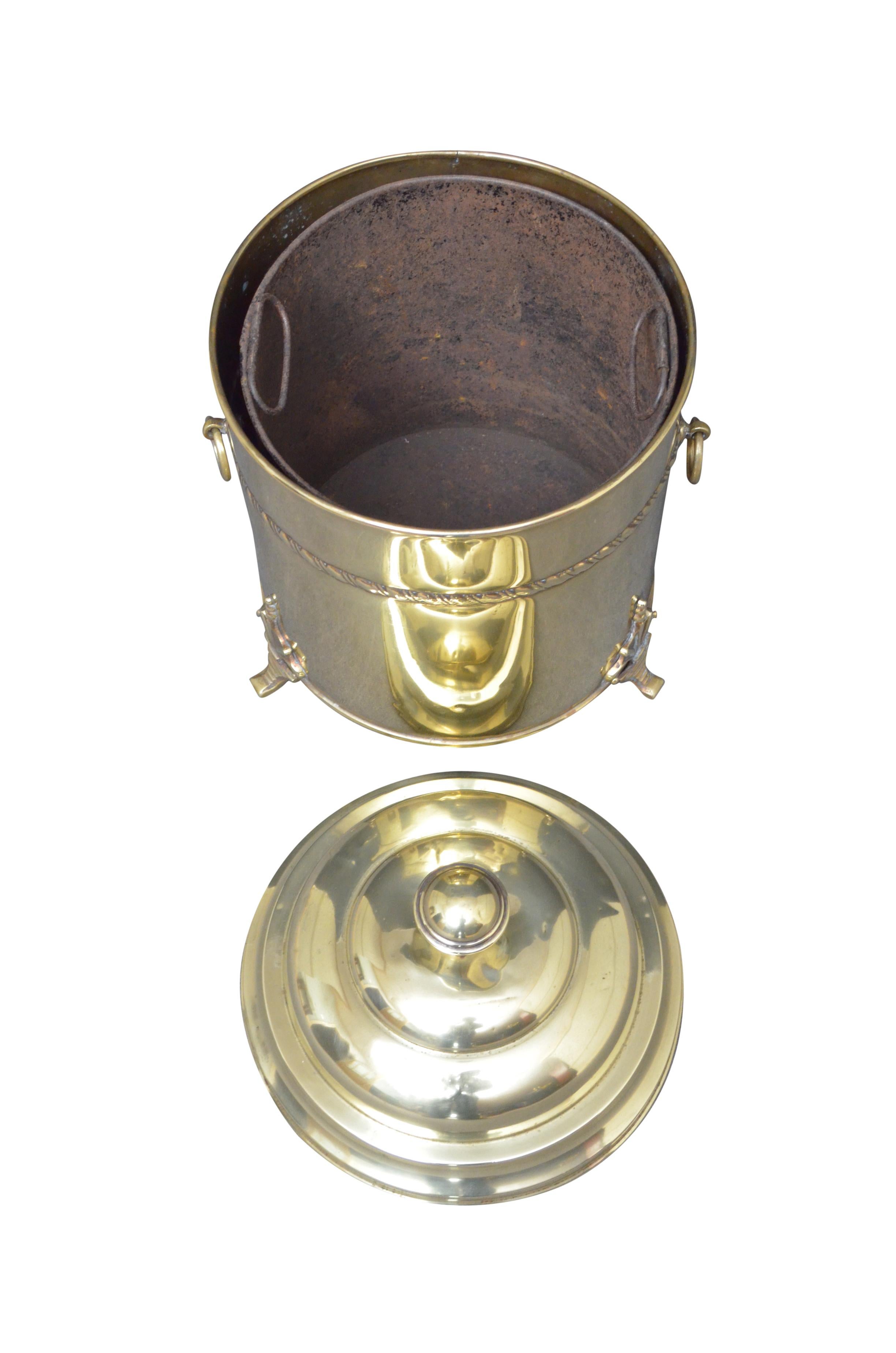 k0026 Edwardian brass coal bin with lift up lid , original liner, decorative band, carrying handles and decorative feet. This coal bucket would make a perfect planter / jardinier, it has been cleaned and polished and it is ready to use at home.