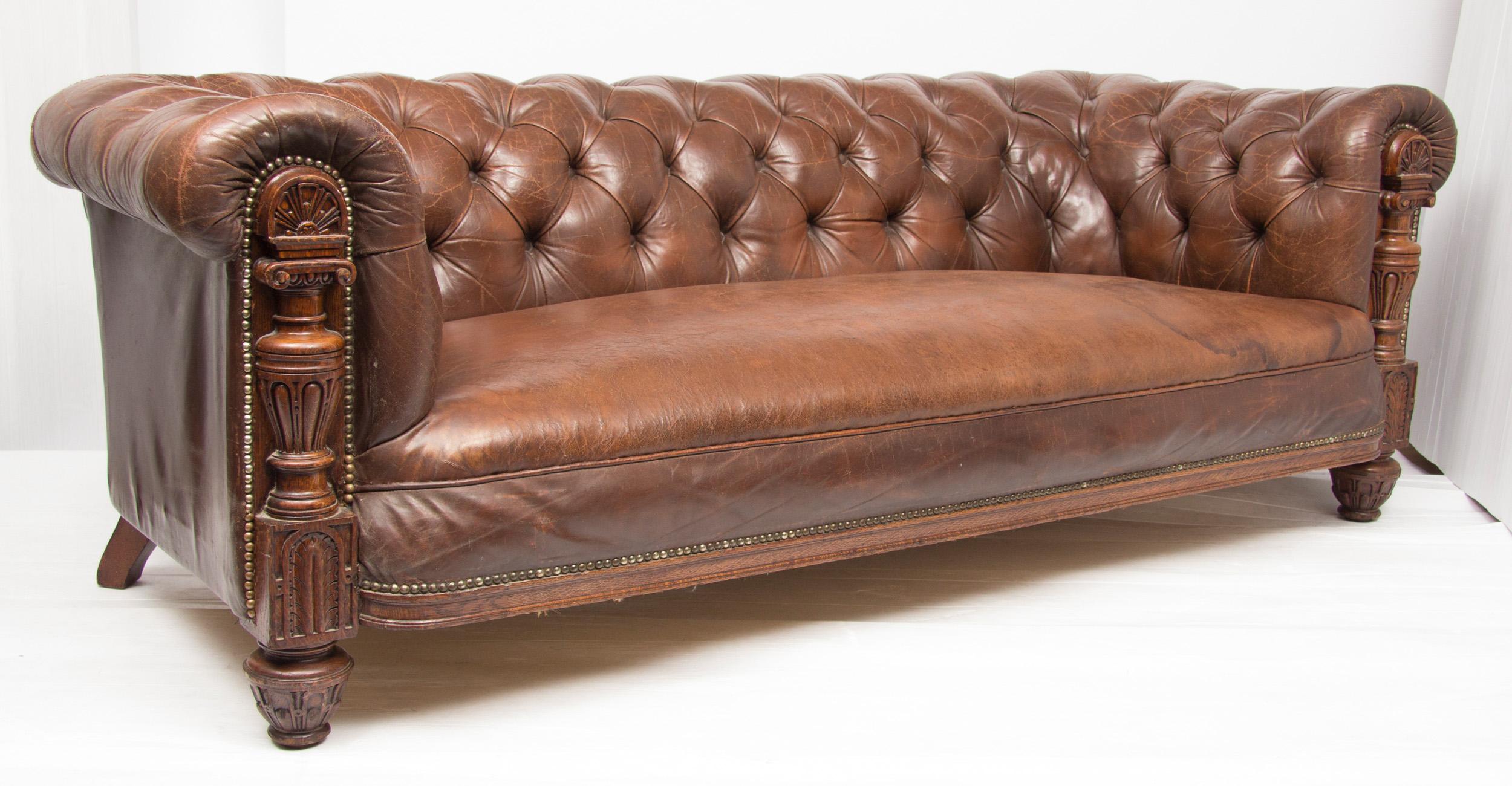 Edwardian leather Chesterfield with carved oak frame.