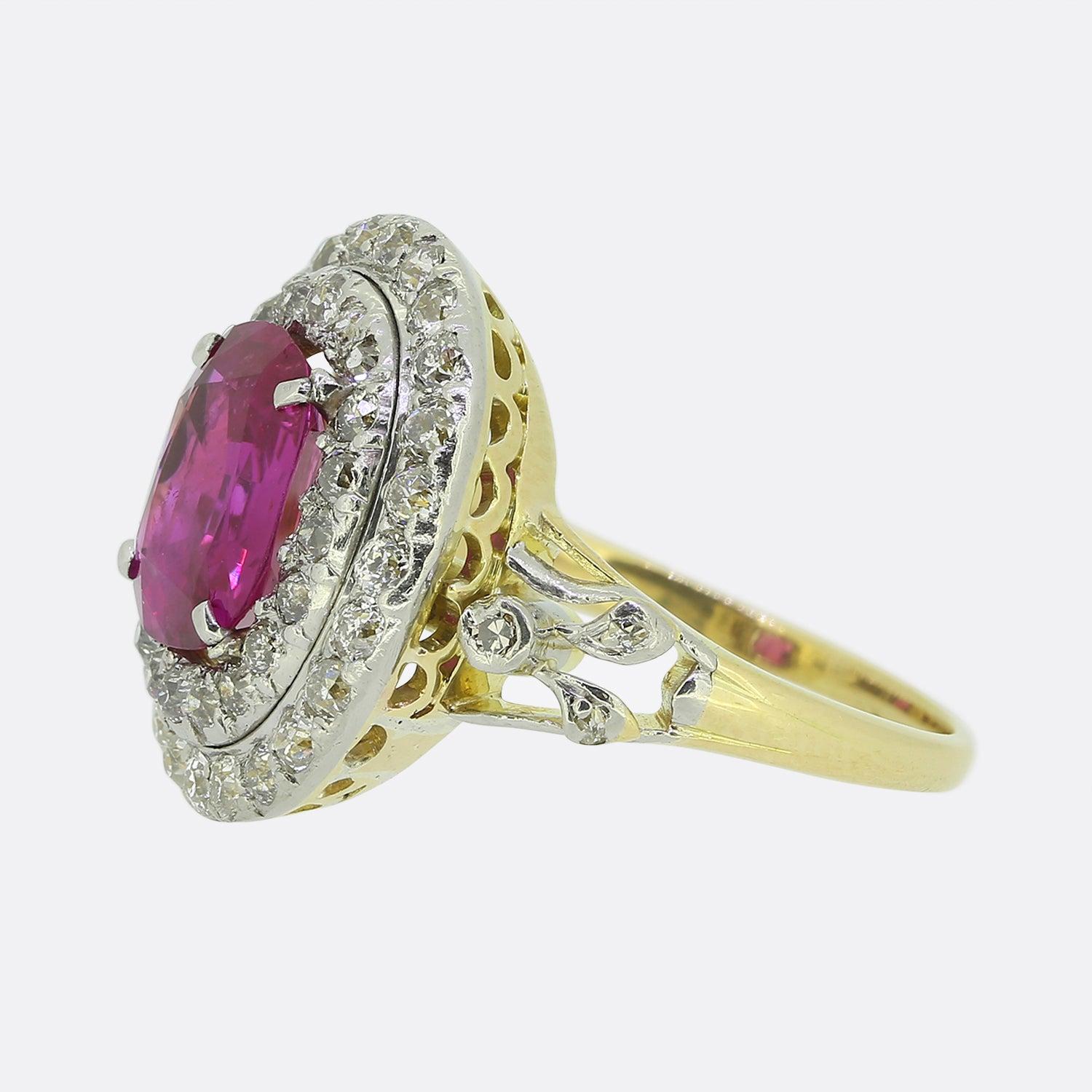 Here we have a sensational ruby and diamond cluster ring dating back to the Edwardian period. A impressive oval faceted natural ruby of Burmese origin sits at the centre of the face. This principal stone possesses a gorgeous red, pinky colour tone