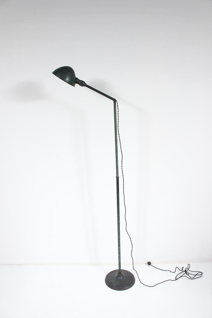 Adjustable All Brass Pharmacy Floor Lamp by C. J. Litscher Electric Co. C. 1920. Small footprint. Featuring a factory patinated all Brass lamp, tubular column, swivel Shade  (7X x 3H), Silver interior, tubular stem, articulating Arm, pressure