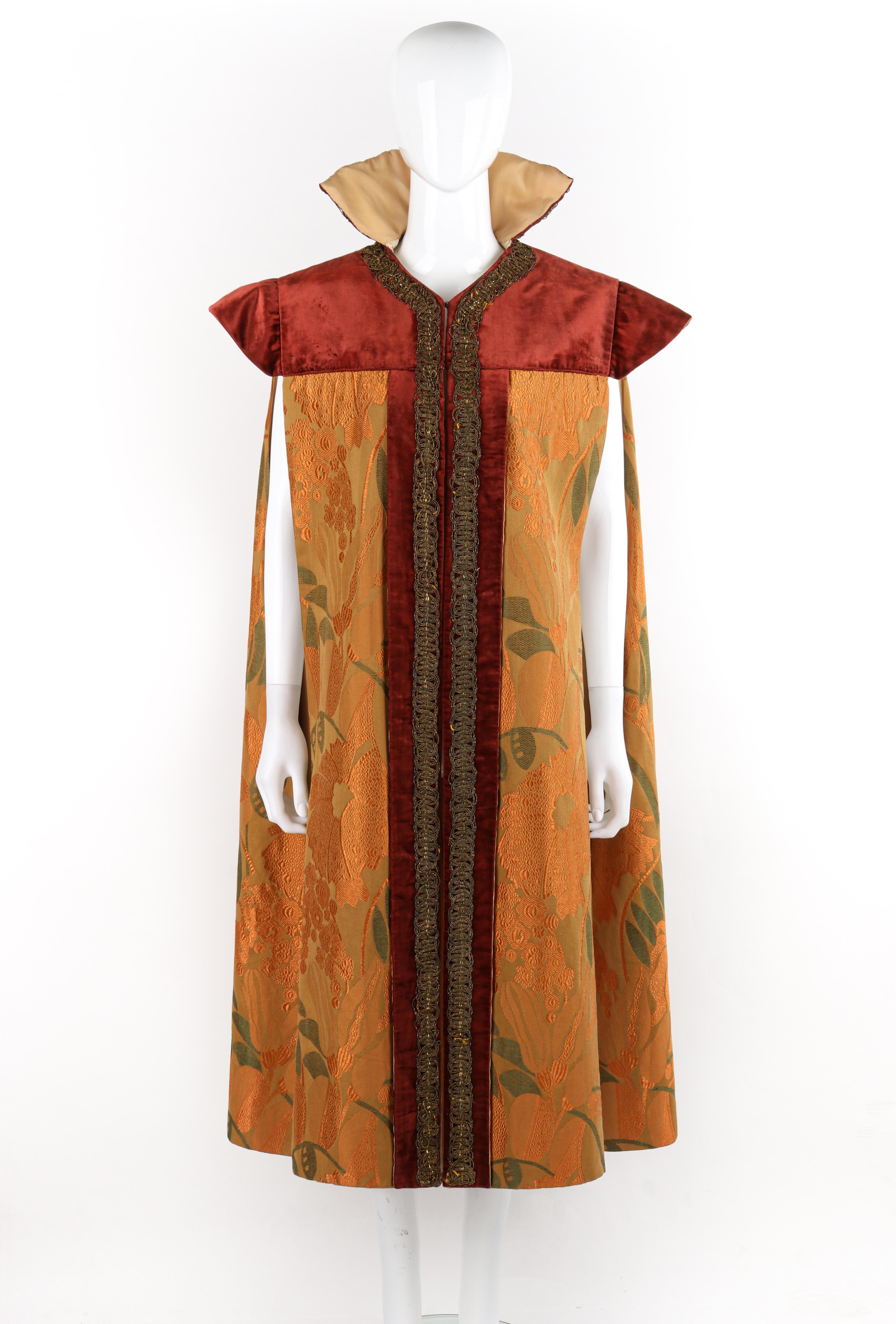 Circa: 1900s
Style: Cape
Color(s): Shades of orange, red, brown, green, gold
Lined: Yes
Unmarked Fabric Content (feel of): Velvet (top yoke), silk (primary fabric), metal (hardware), cording (trim)
Additional Details / Inclusions: Edwardian era
