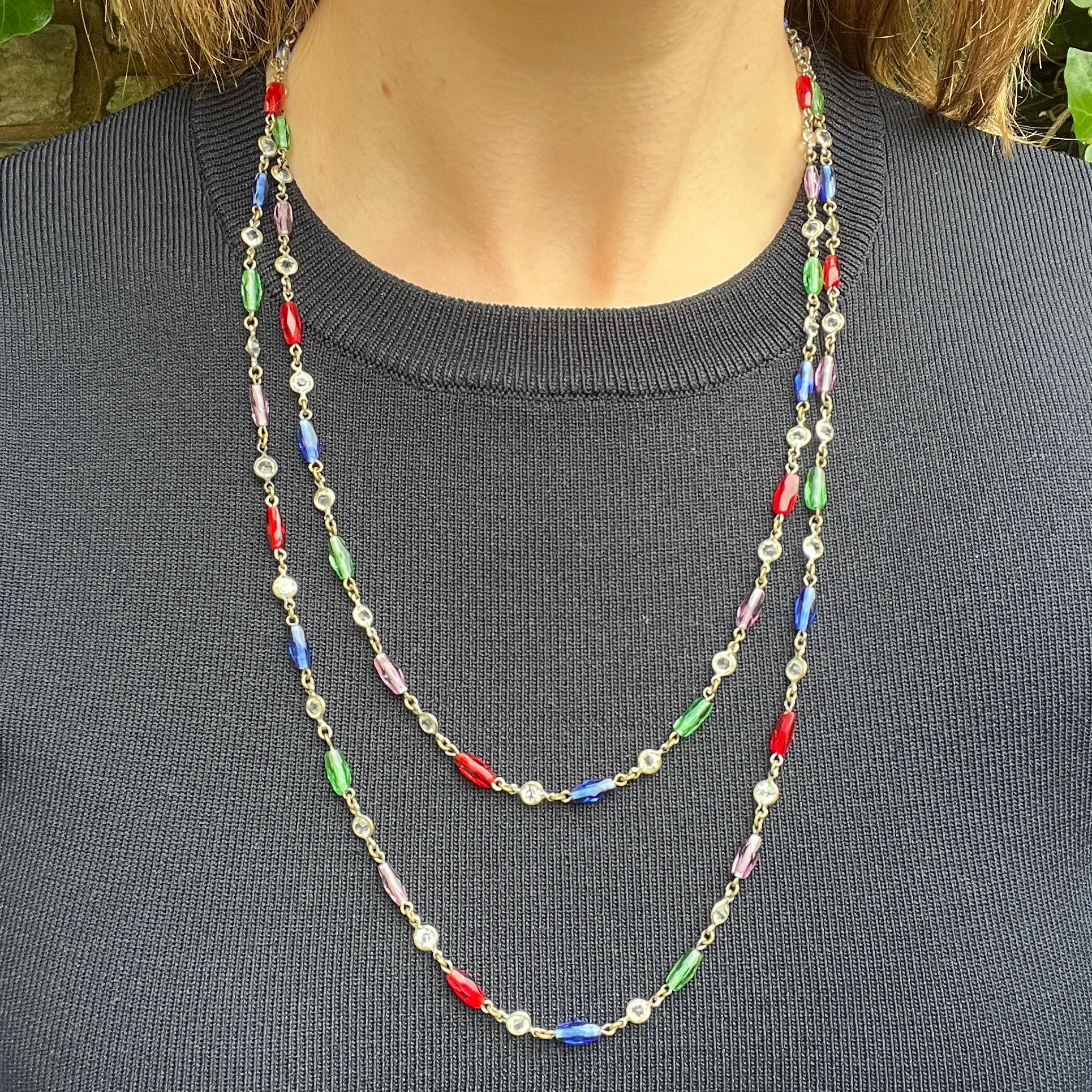 This elegant long chain was created c.1900. It features an unusual combination of coloured glass and crystal. 

Condition Report:
Very Good - One link is possibly a later replacement. This is only apparent upon very close inspection and does not