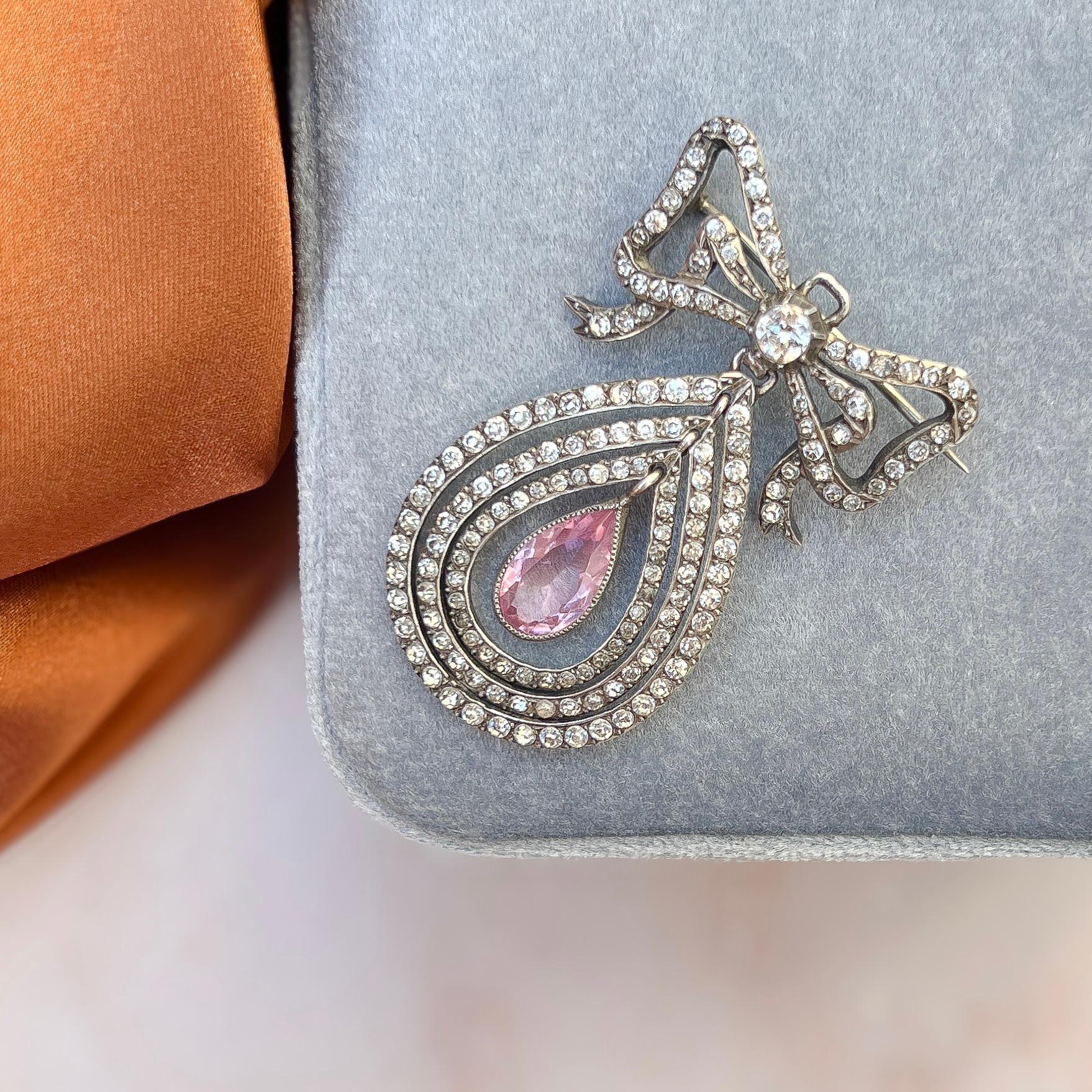 This beautiful pendant was created c.1900. It features an elegant bow design. 

Condition Report:
Excellent

The Details...
This brooch/pendant is constructed from silver. It tests as being made from silver and is stamped with two very faint
