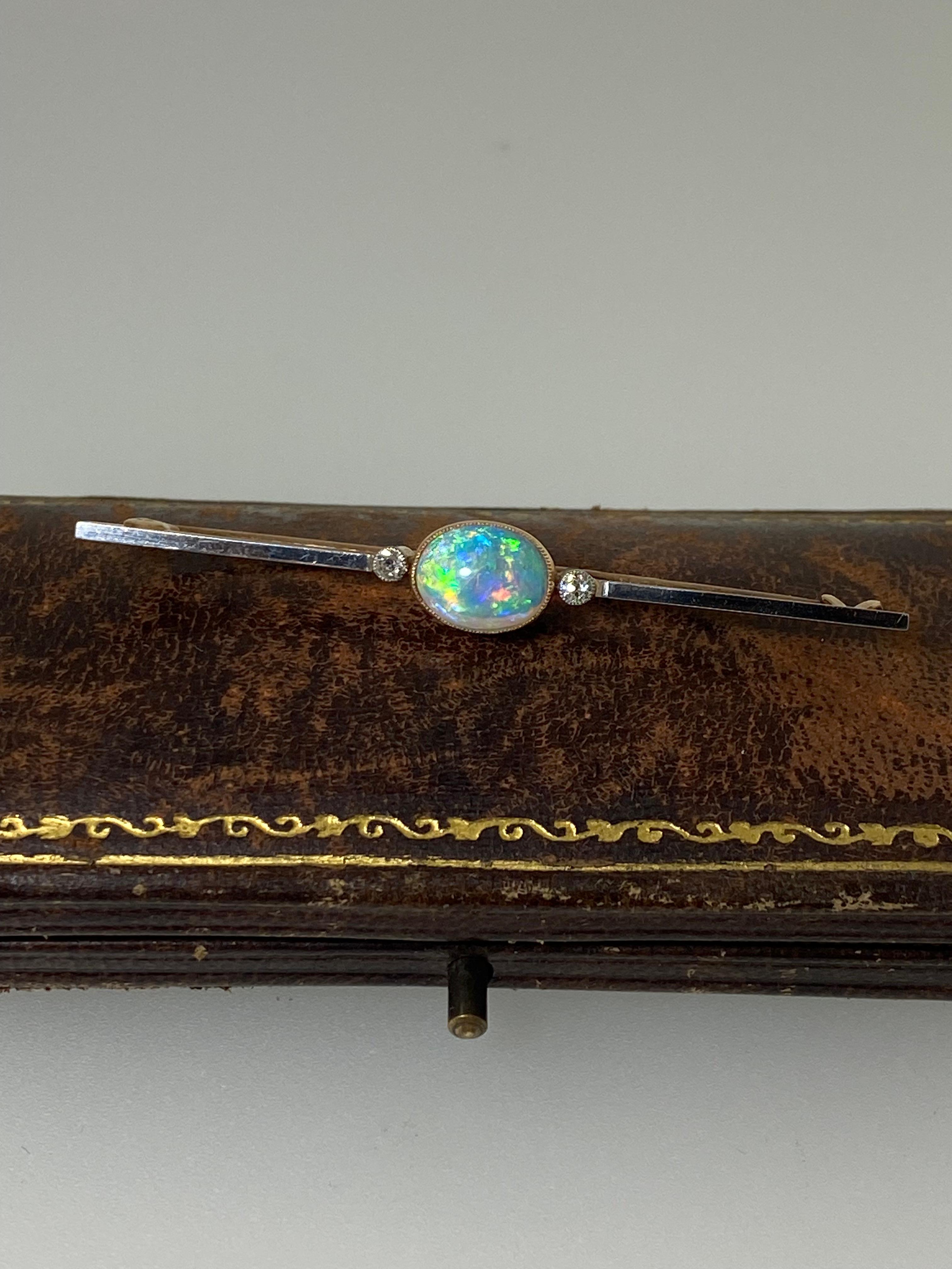 Crafted with refined elegance
this stunning Bar Brooch 
is dating from Edwardian circa 1920's period, 
yet it's in beautiful condition 

~~

Of lovely bar design, 
it centers a bezel millegrain set 
Solid Semi-Black Crystal Opal 
(10mm x 7mm) of