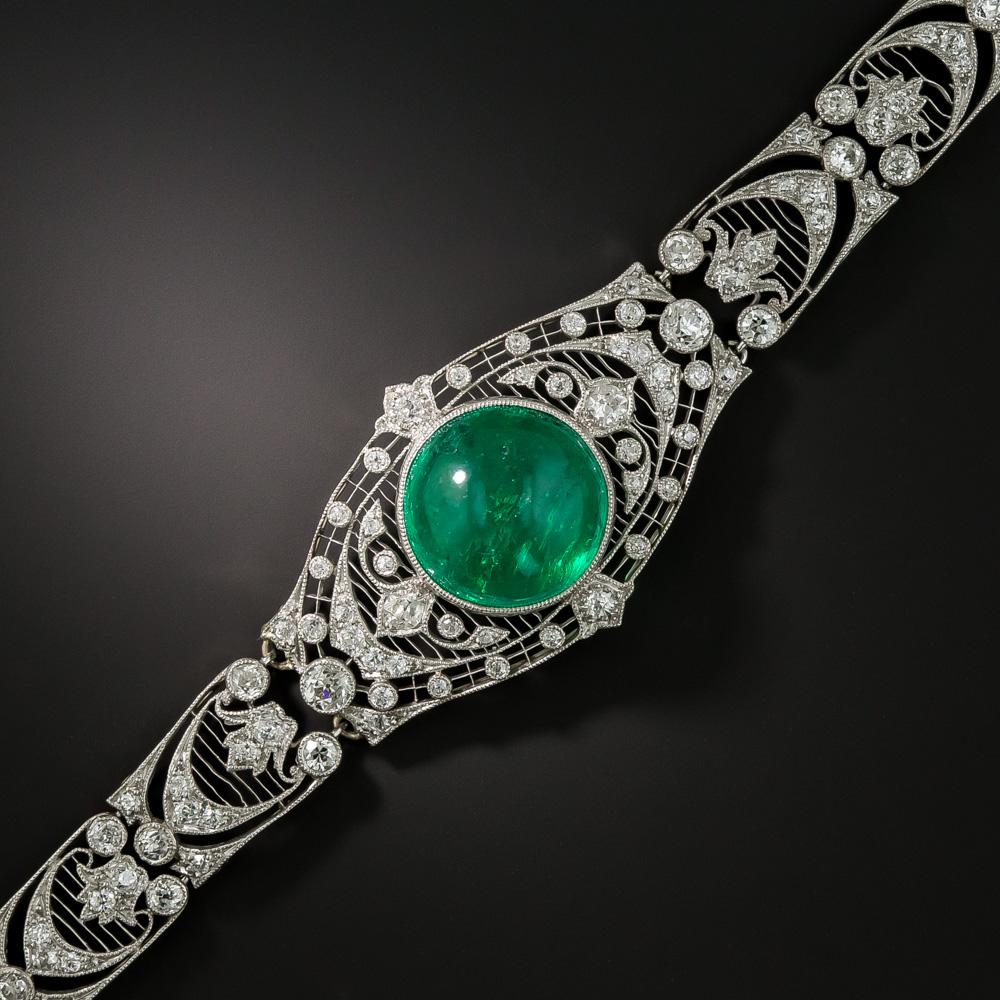 Magnificent is the word to describe this light and lacy Edwardian bracelet, dating from the very beginning of the 20th century. This diaphanous adornment was lovingly constructed around a bright and luscious green 10 carat round cabochon emerald.