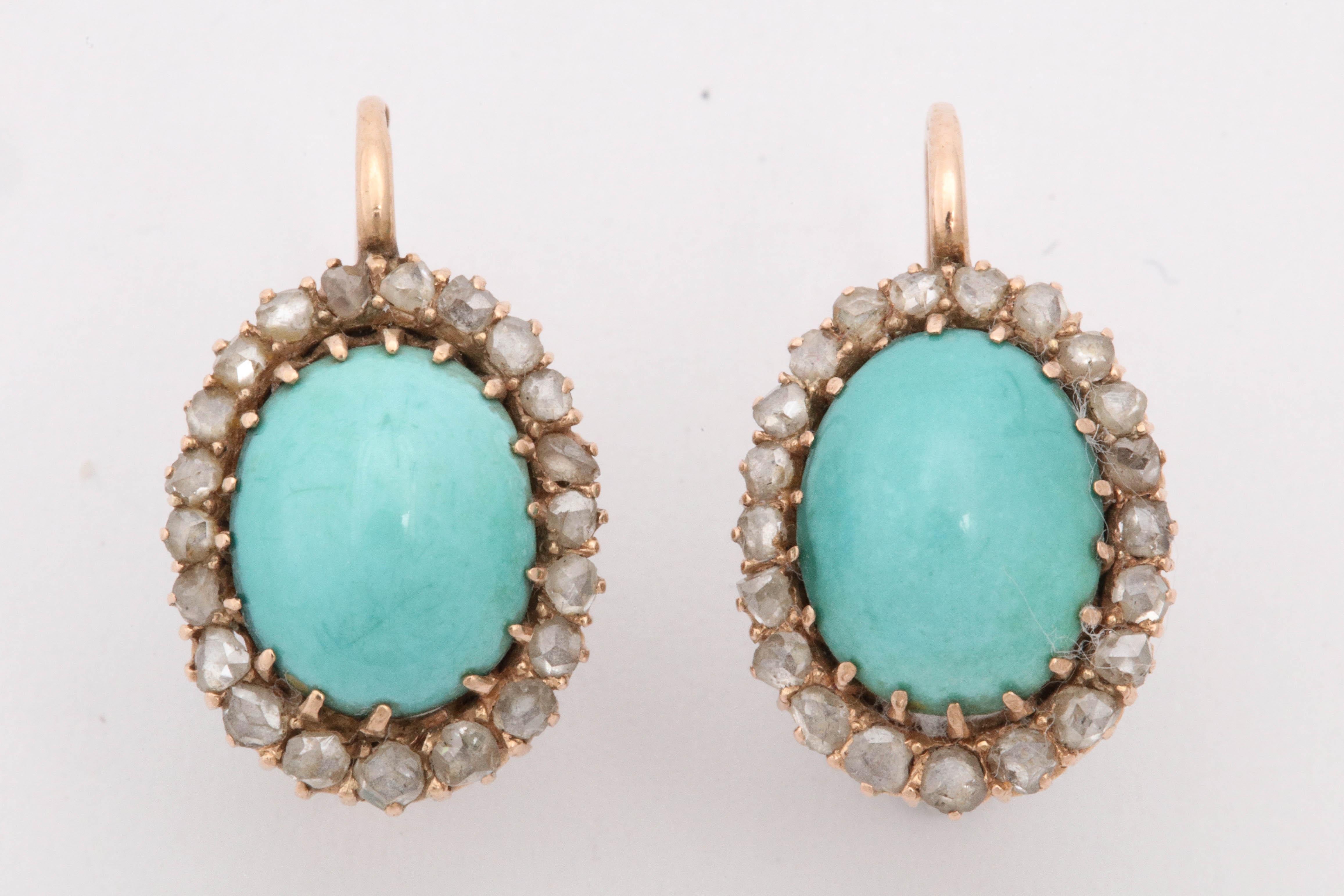 One Pair Of Ladies Handmade 18kt Gold Dangle Drop Earrings Embellished With [2] Large Oval Cut Cabochon Turquoise Stones Measuring Approximately 12 MM Each Stone. Further Designed With Numerous Crown Set Rose Cut Diamonds Weighing Approximately 1.50