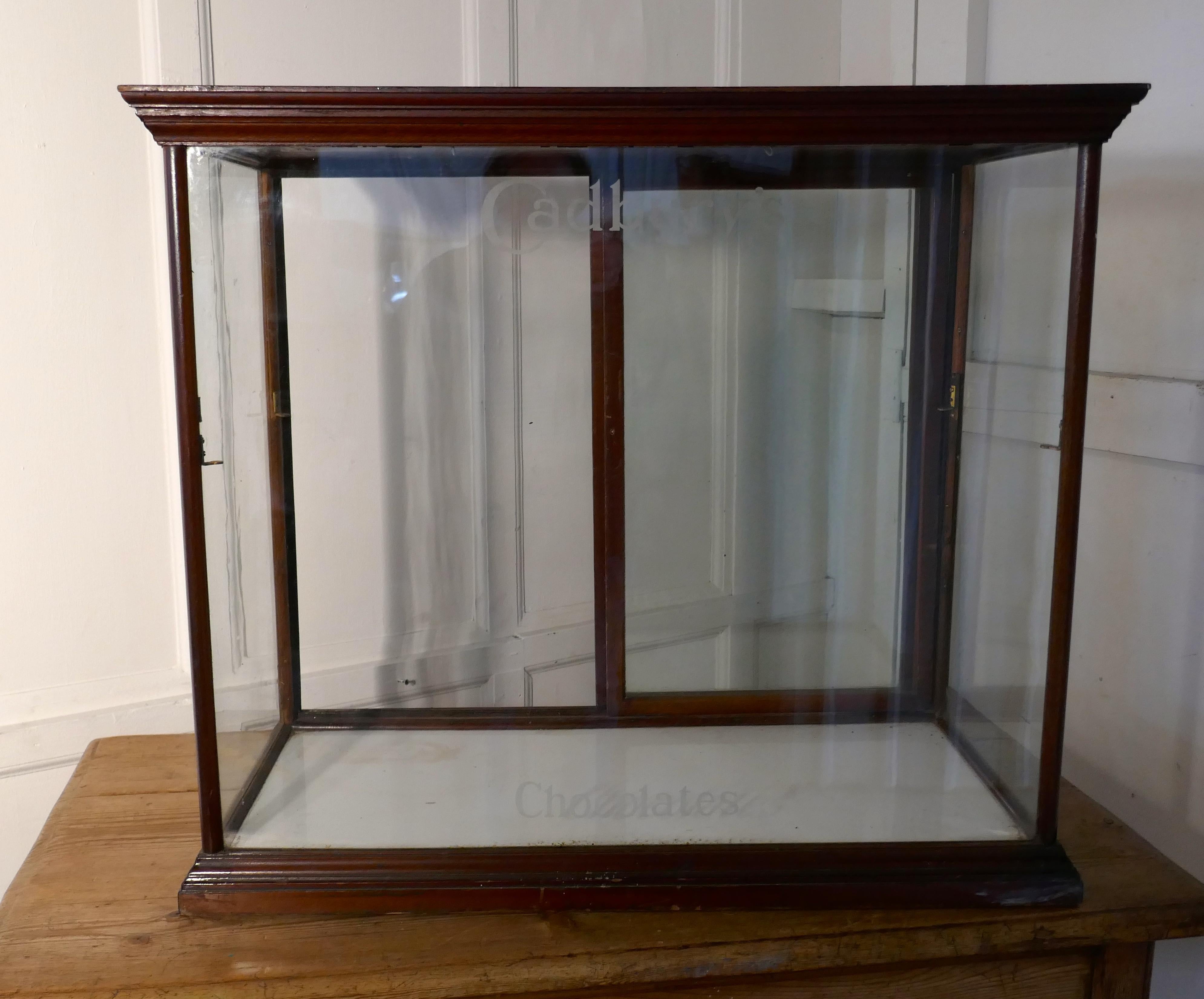 Edwardian Cadbury’s counter top sweet shop display cabinet

This glazed shop display cabinet is made mahogany, the glass has etched lettering on the front of the cabinets saying Cadbury’s at the top and Chocolates at the bottom 

The cabinet has