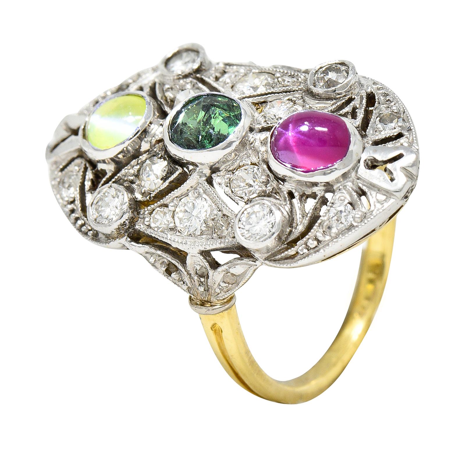 Dinner ring is oriented North to South and depicts a stylized X motif. Centering an oval cut alexandrite weighing approximately 0.42 carat. Bluish green in color in fluorescent light with strong color-change to grayish purple/red color in