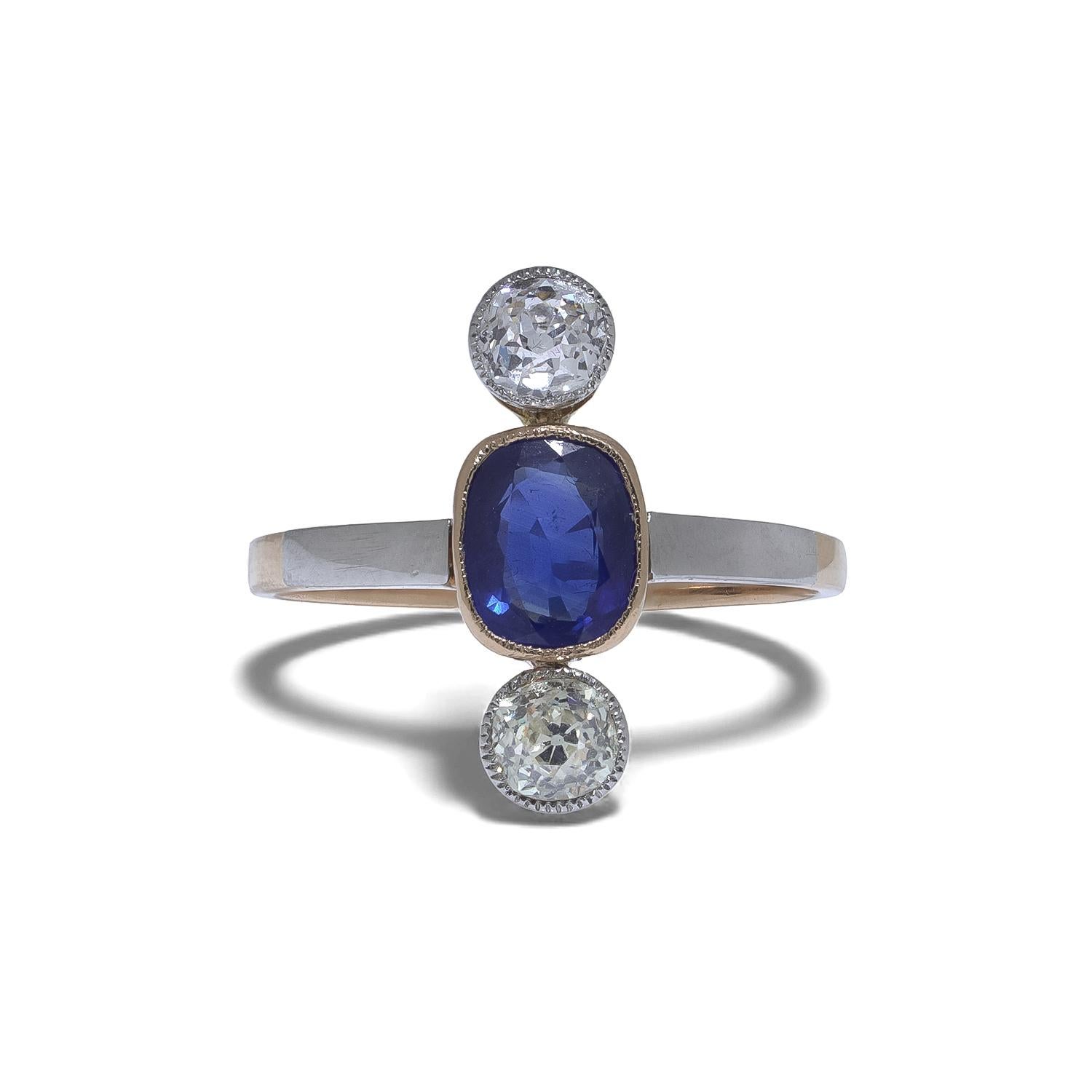 An Edwardian natural sapphire and diamond ring crafted circa 1910 in 15KT gold with platinum settings. The design centres around a vivid 1.00 ct natural Ceylon blue sapphire, displaying exceptional colour saturation characteristic of fine Ceylon