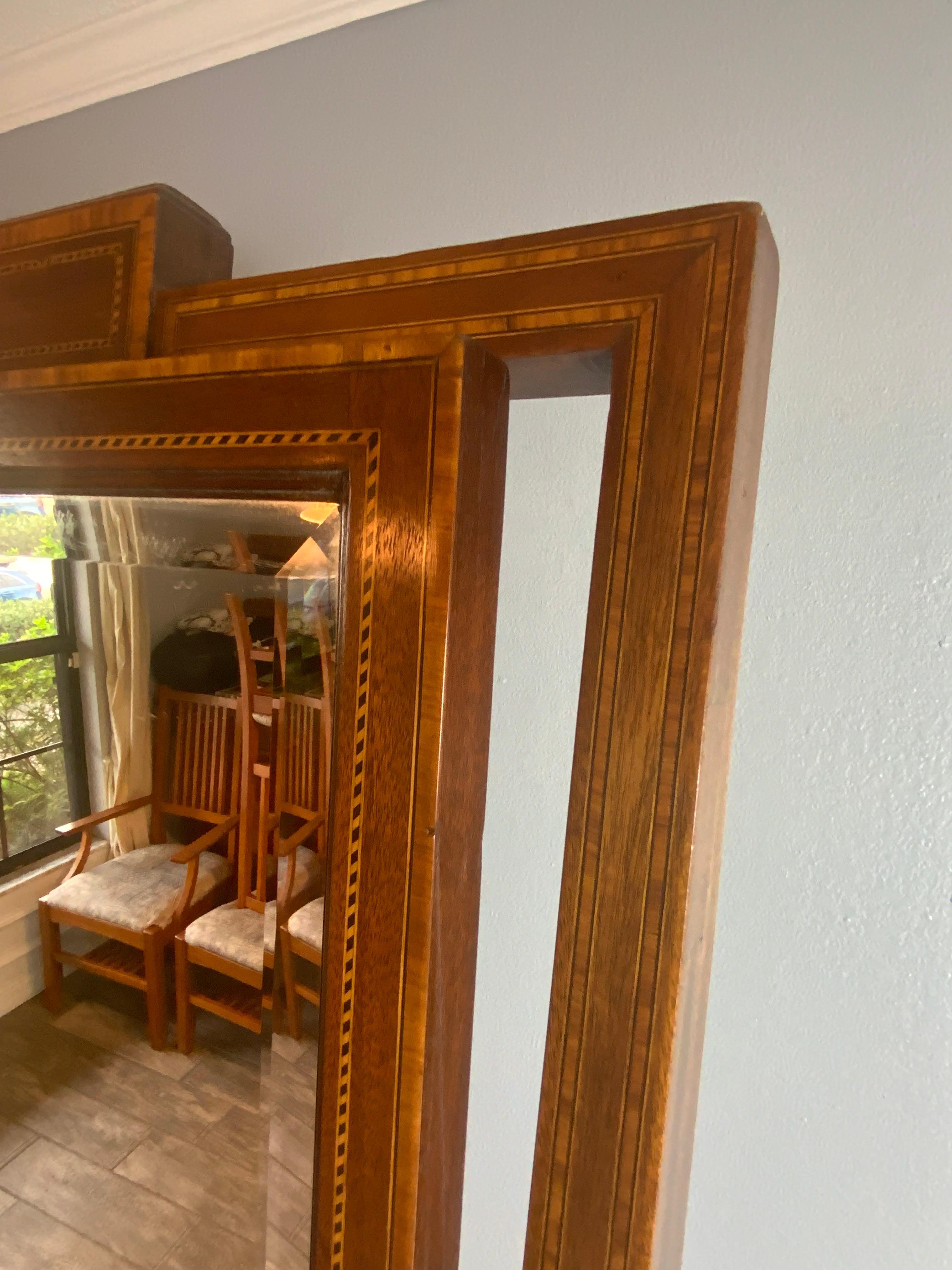 Superb Mahogany inlay Edwardian Cheval mirror in very good original condition. Original beveled glass mirror in a tight strong frame resting on the original Brass cup casters. Beautiful aged color and patina on the original surface. 
