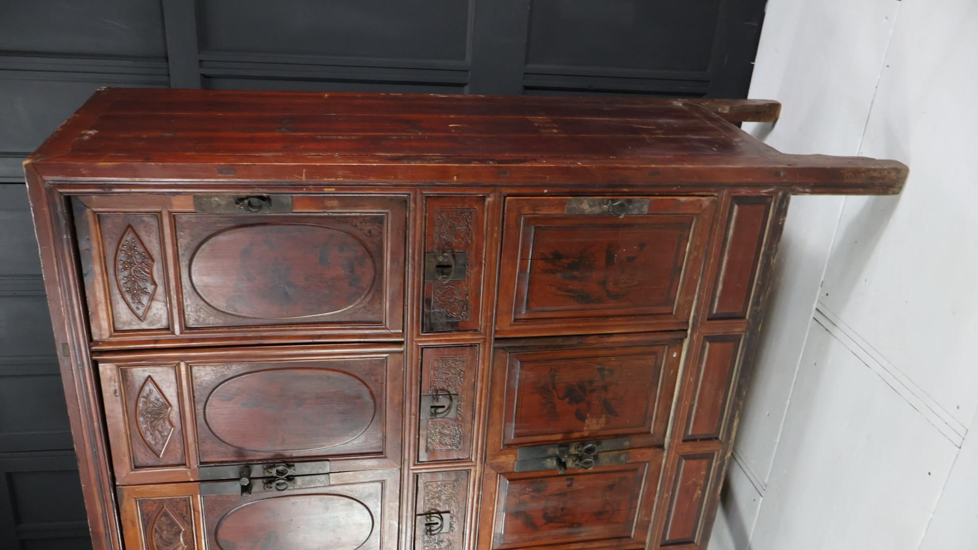 Late Edwardian/early Victorian chinoiserie lacquered cupboard.
Retaining its warm, sunburnt red/orange colour with decorative stencilled images on each door.
With original door handles and hinges the cupboard comprises of eight doors with a large