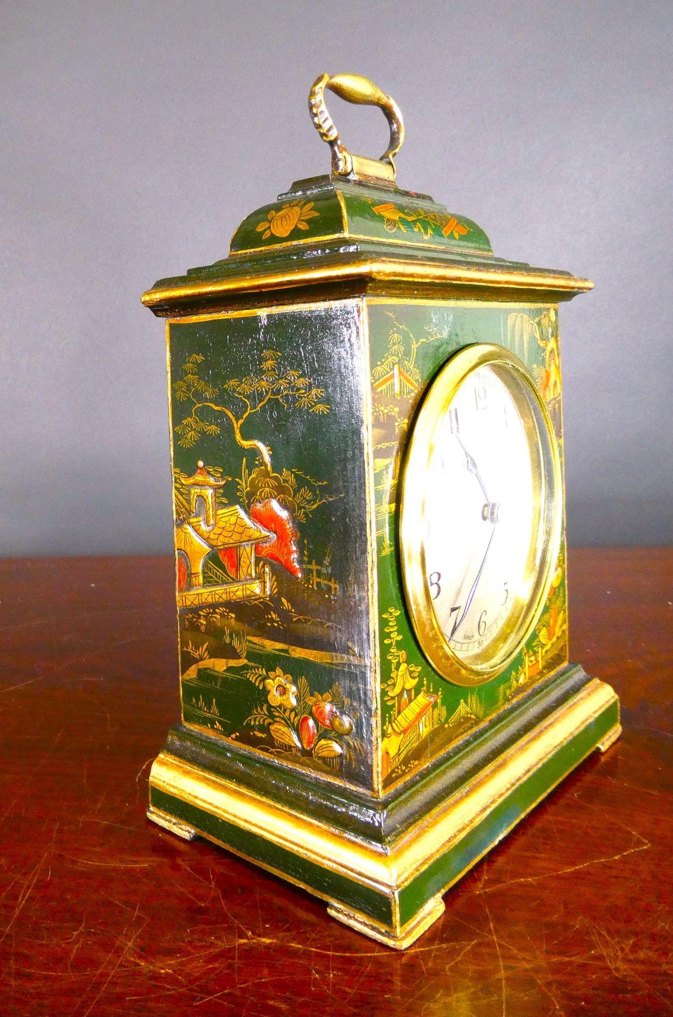 Edwardian Chinoiserie Decorated Mantel Clock, Asprey, London.

Edwardian mantel clock housed in a bell top case with raised chinoiserie scenes on a green ground resting on gilded block feet and surmounted by a brass carrying handle.
Silvered dial