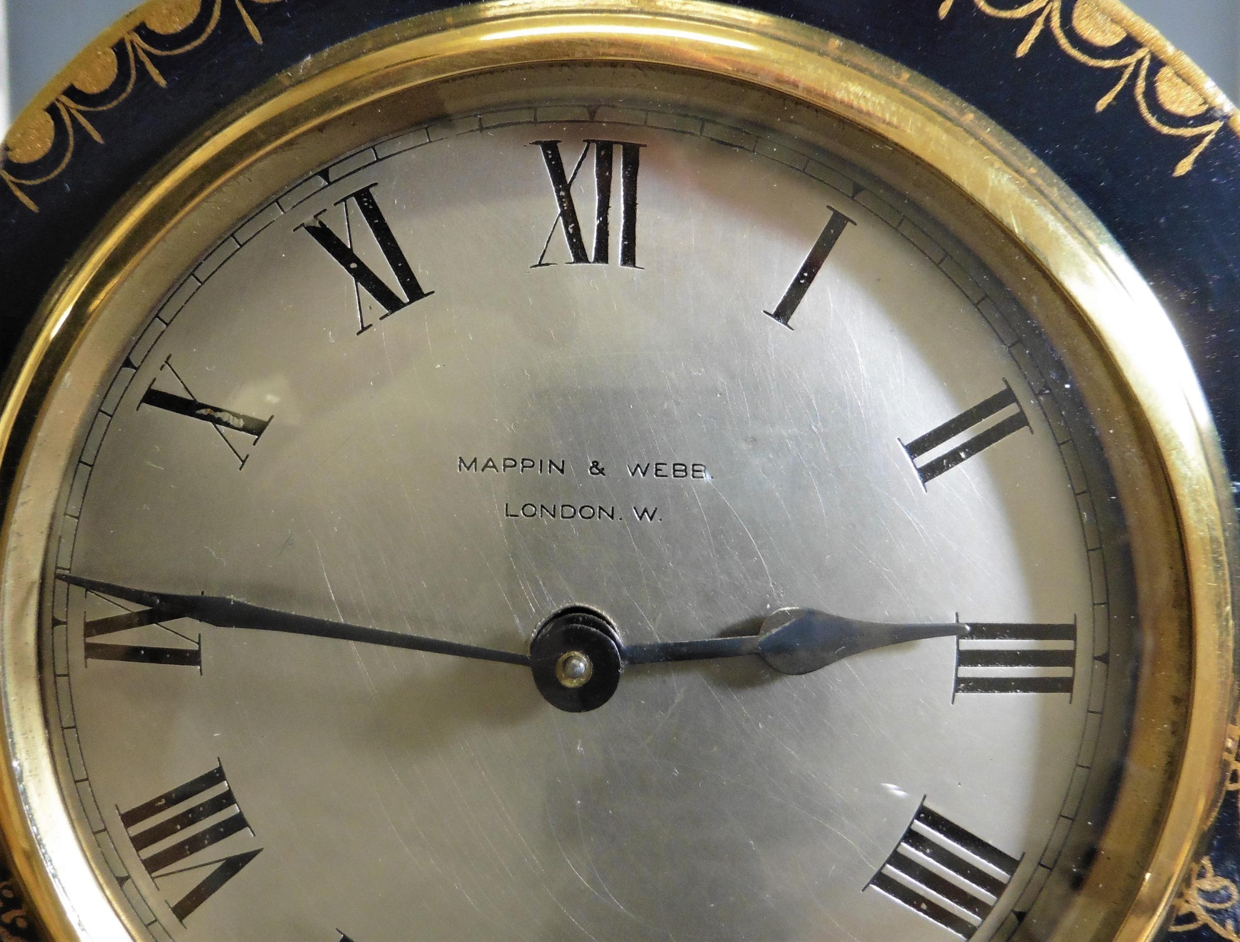 Edwardian mantel clock in a serpentine top case with beautiful raised chinoiserie decoration on a dark blue ground standing on gilded pad feet.

Silvered dial with Roman numerals and original ‘blued’ steel hands signed ‘Mappin & Webb’.

Eight